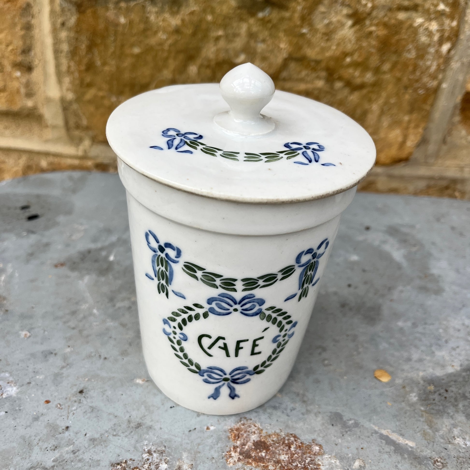 Set of ceramic storage jars with French text and decorative elements