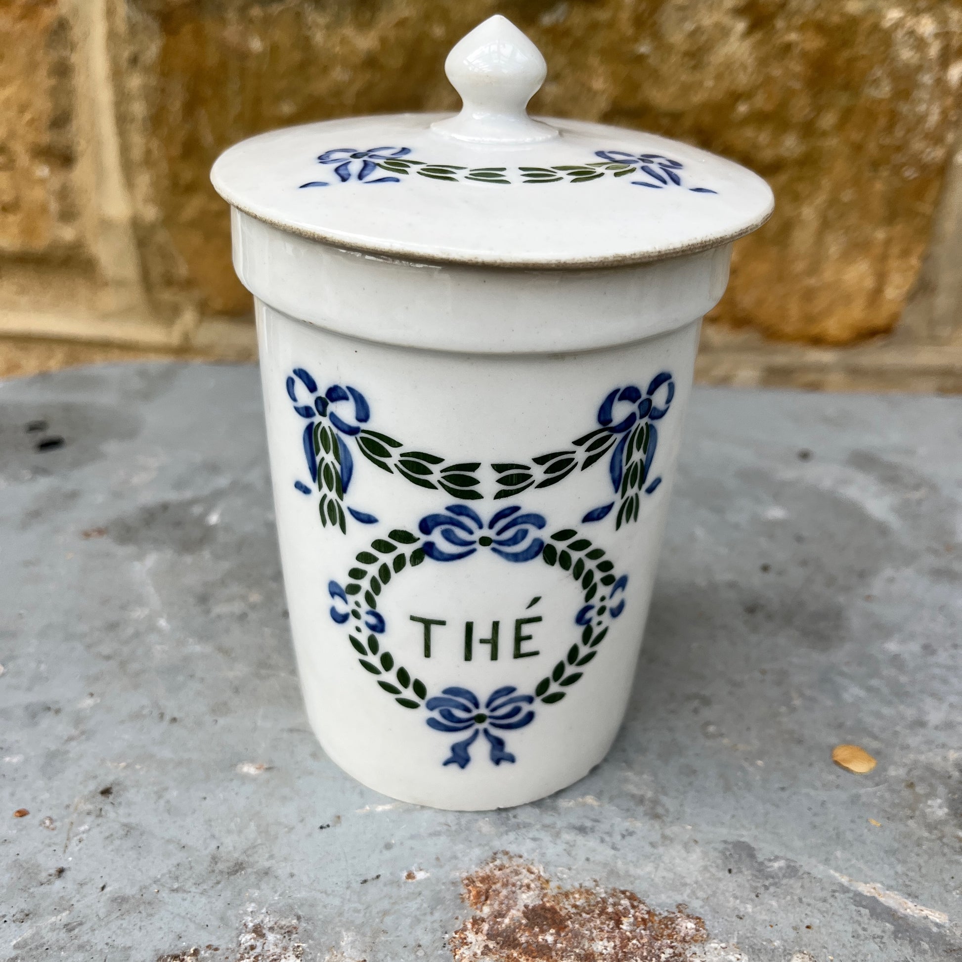 Set of ceramic storage jars with French text and decorative elements