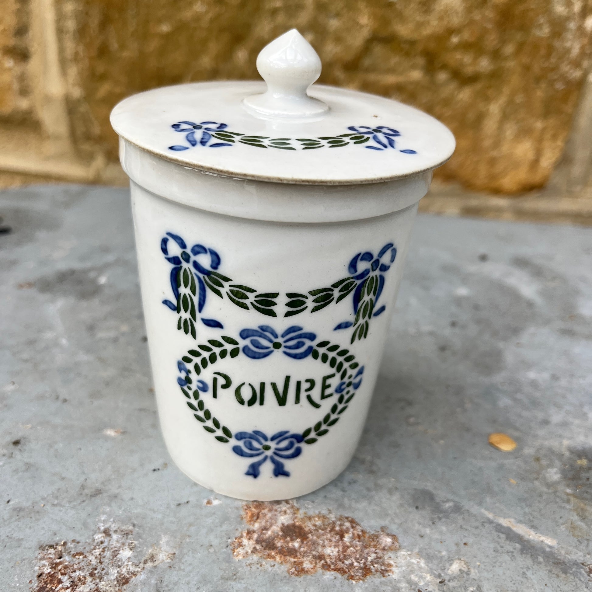 Set of ceramic storage jars with French text and decorative elements