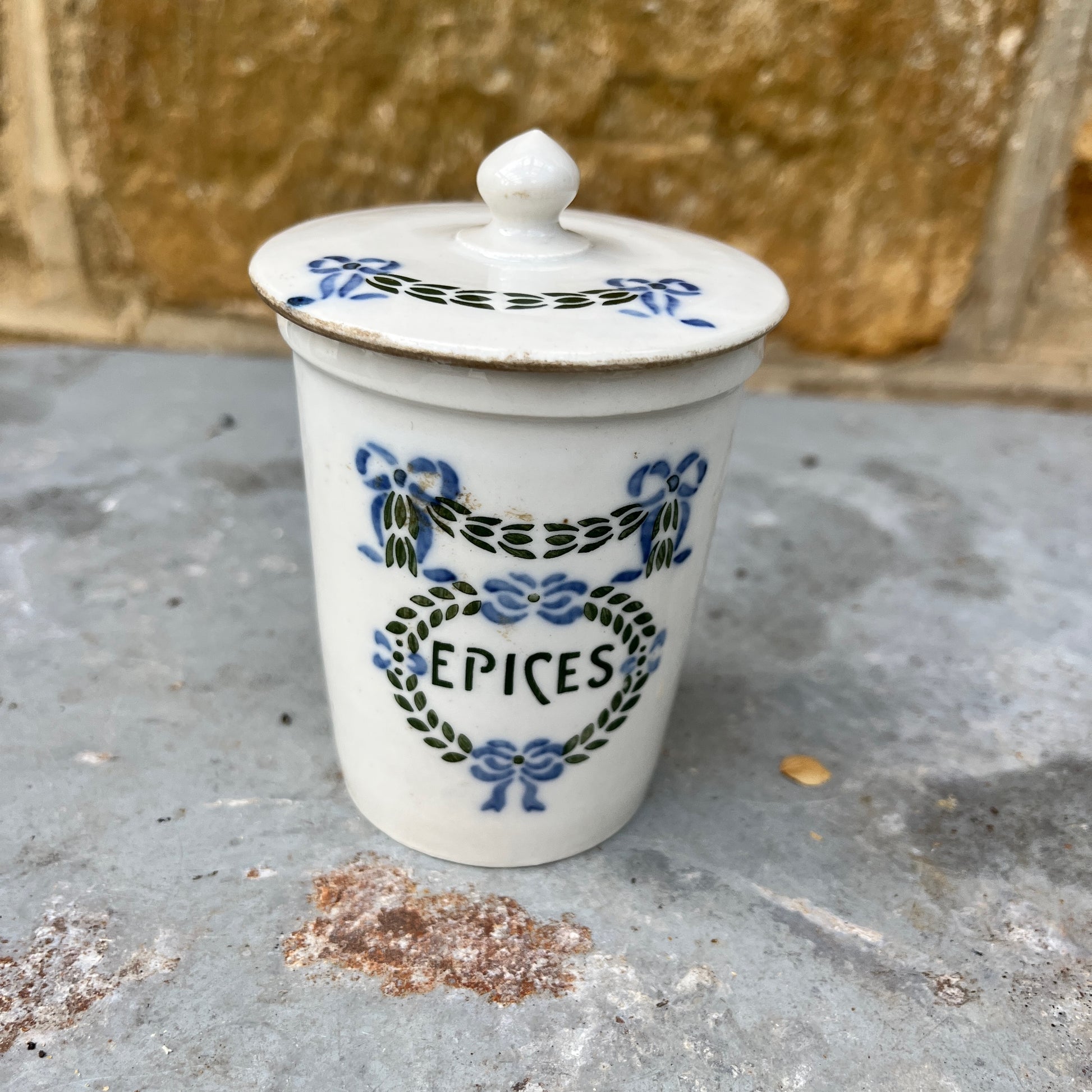 Set of ceramic storage jars with French text and decorative elements