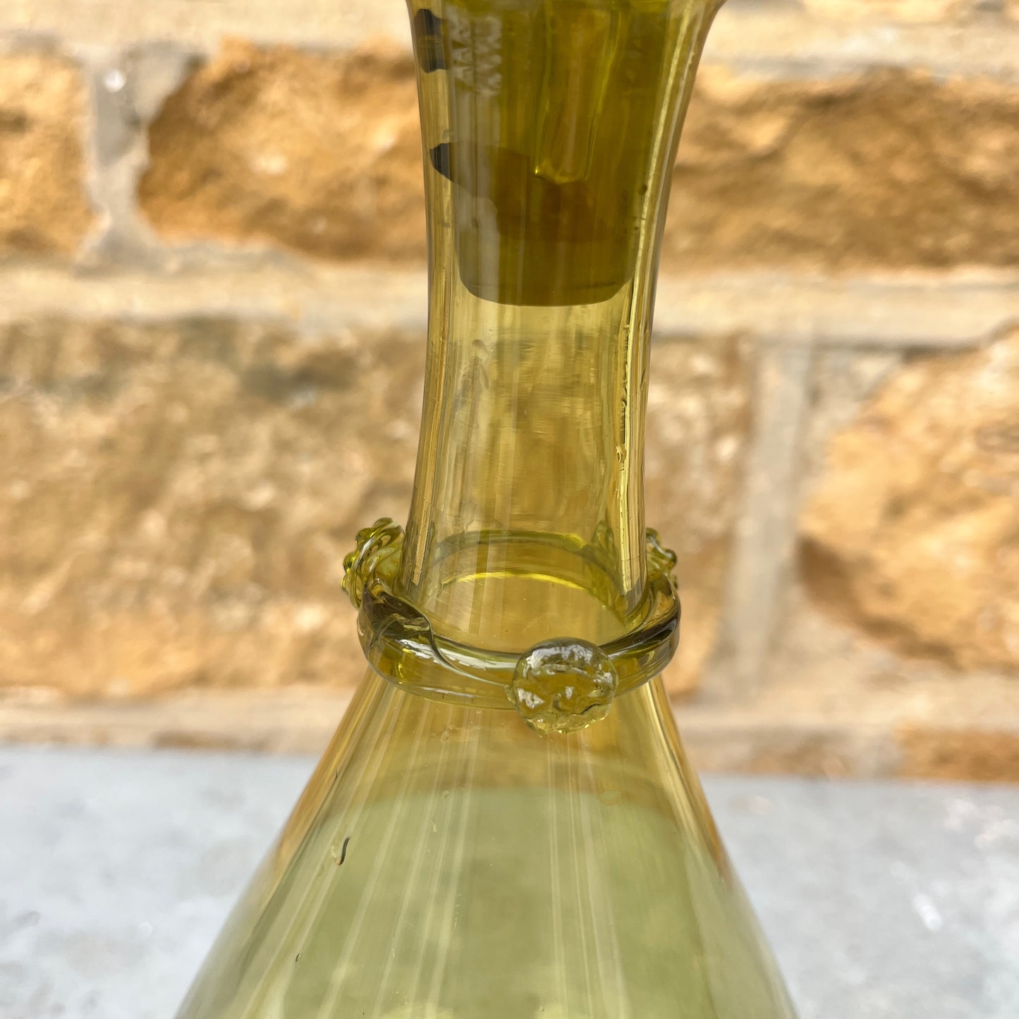 Green glass decantor with a textured stopper