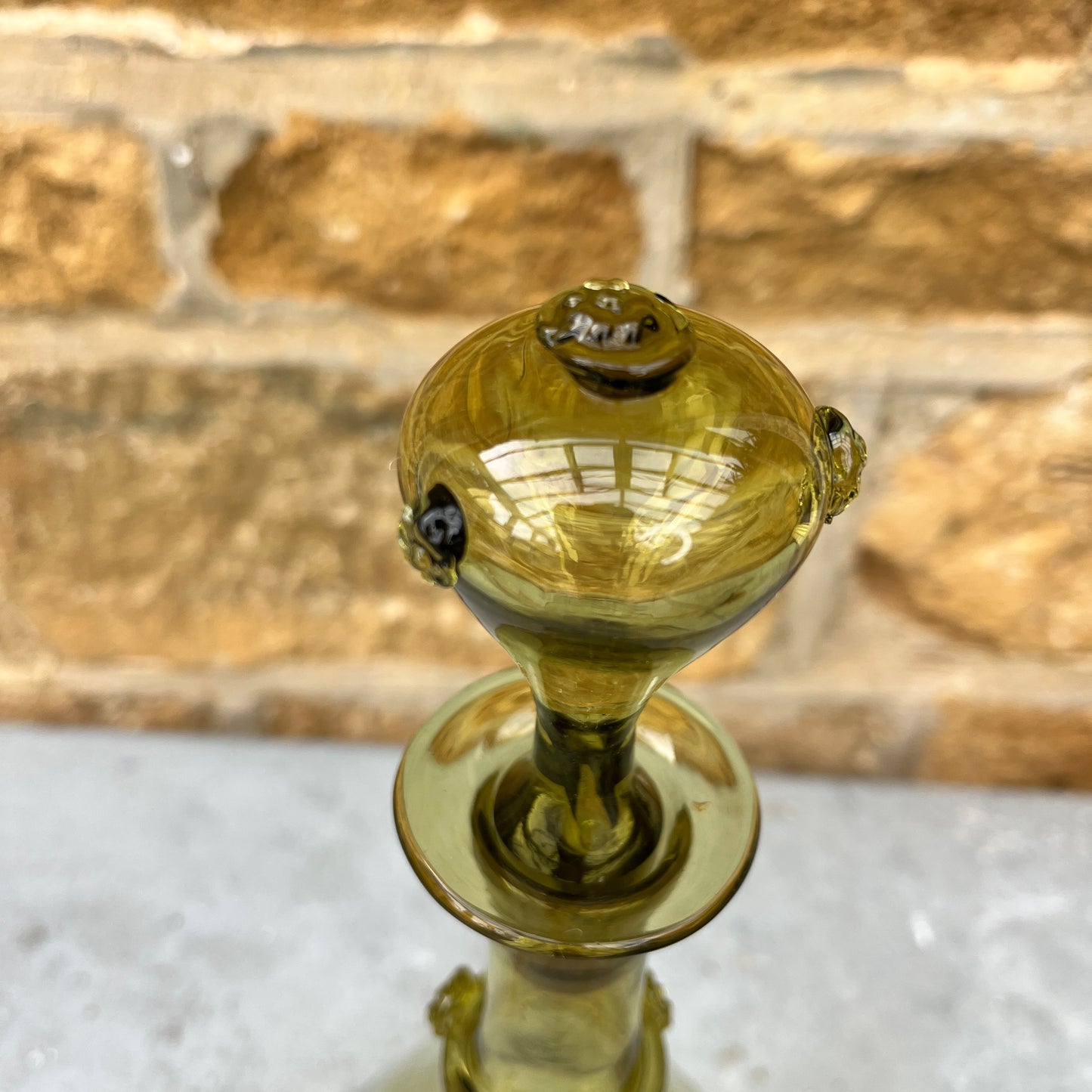 Green glass decantor with a textured stopper