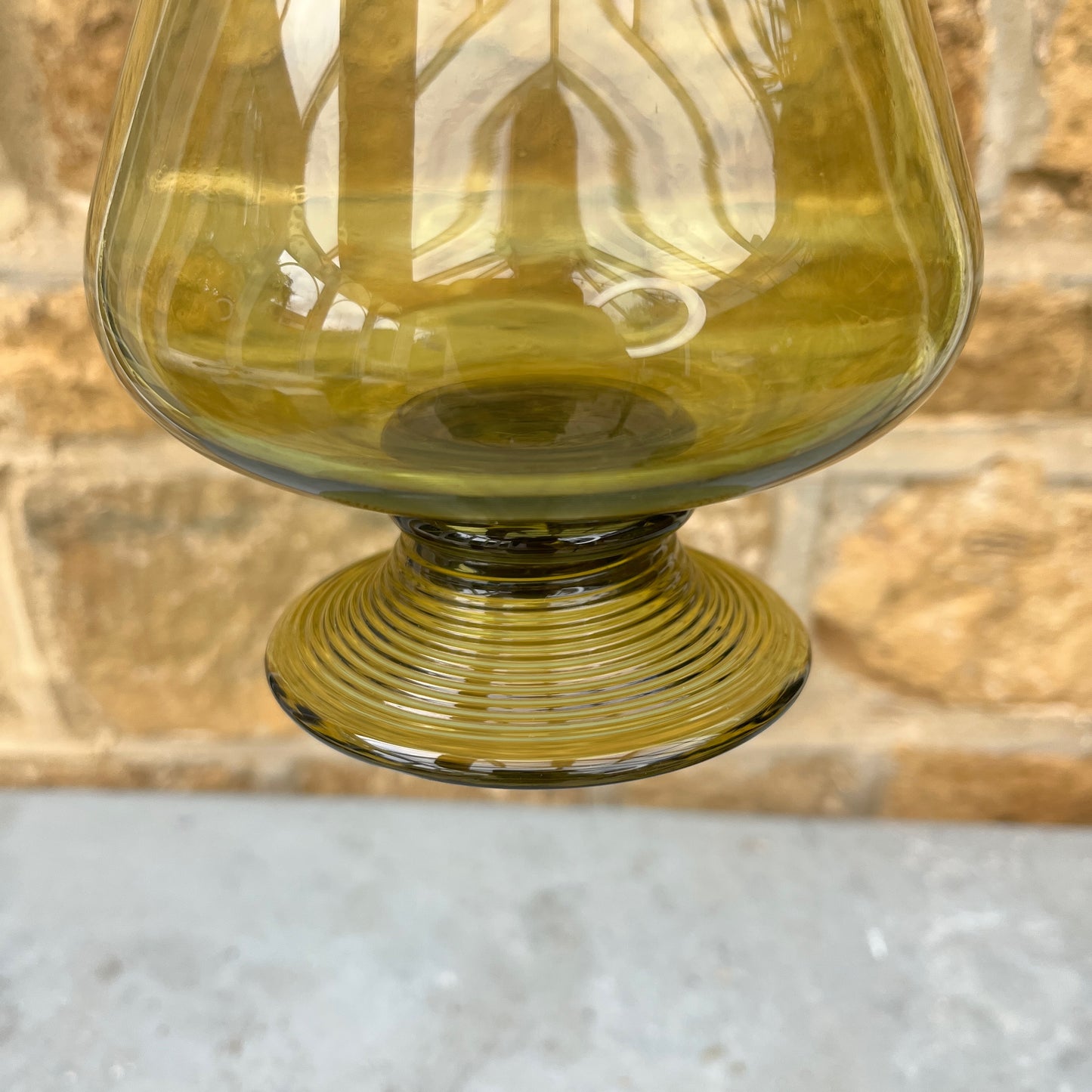 Green glass decantor with a textured stopper