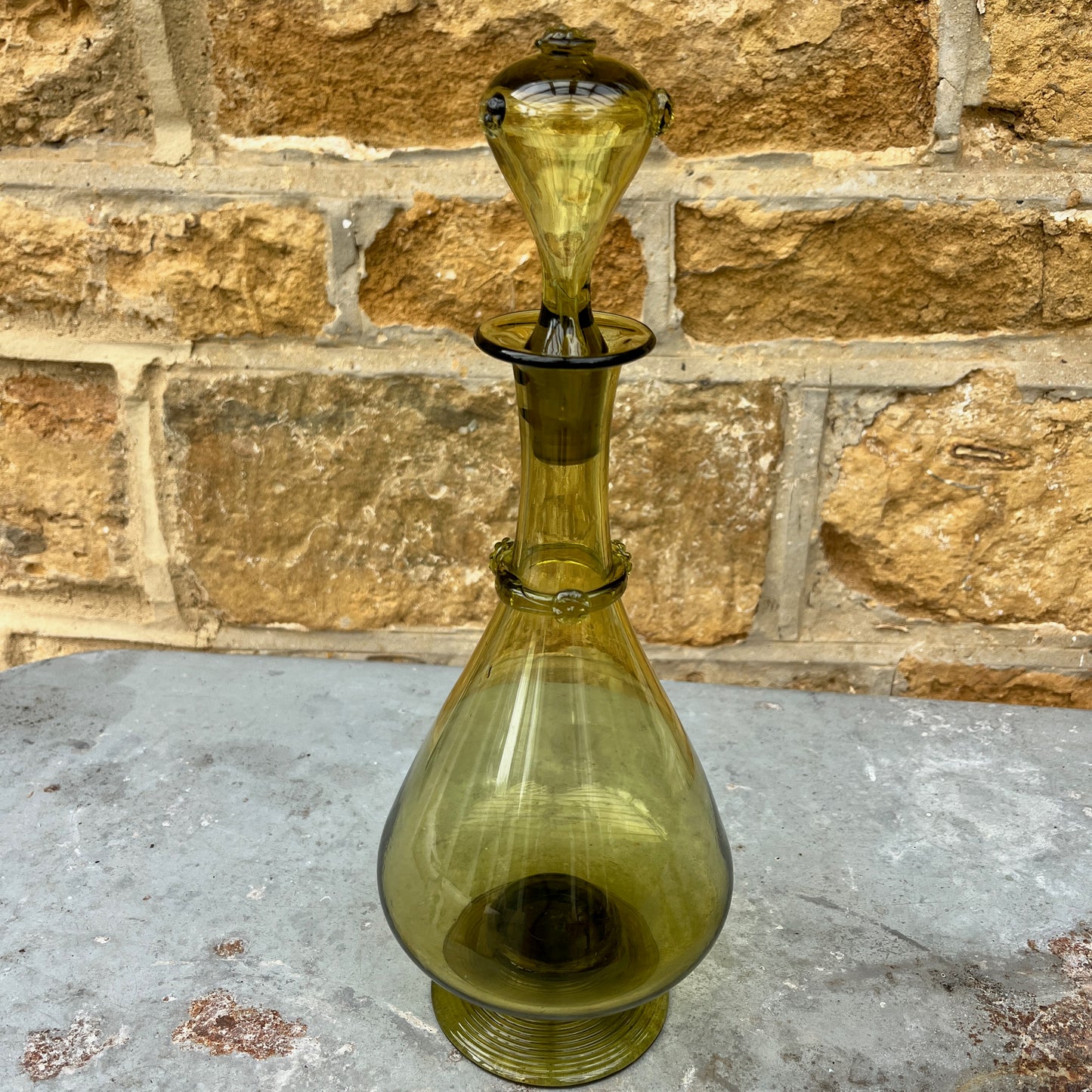 Green glass decantor with a textured stopper