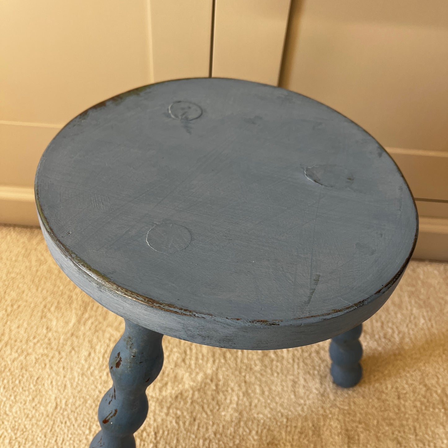 Wooden stool with three turned bobbin-style legs - painted blue and distressed