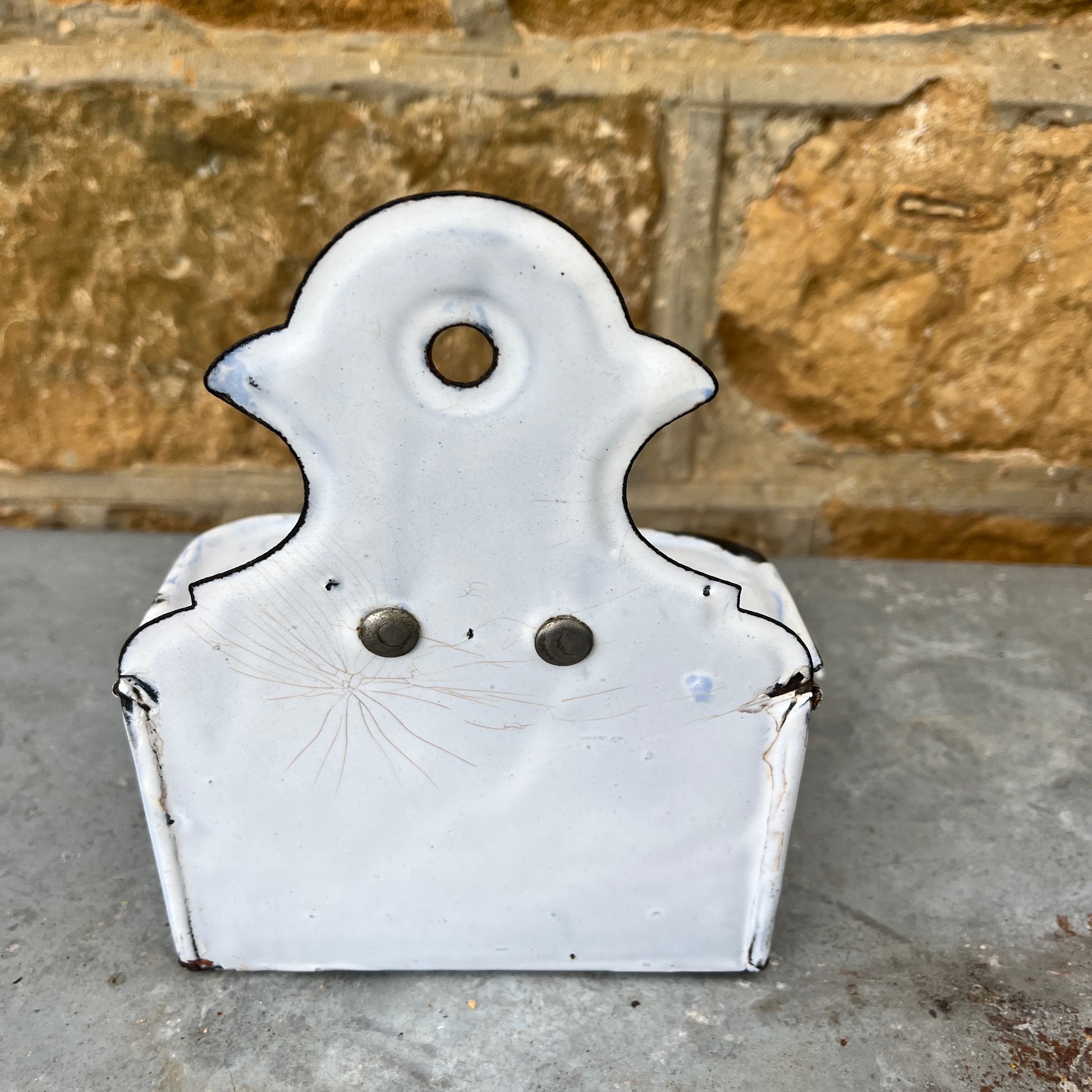 A vintage enamel allumettes box with a white background and blue hand-painted  geometric patterns, featuring a smooth, glossy finish. The small, rectangular box has a hinged lid, exuding classic French charm