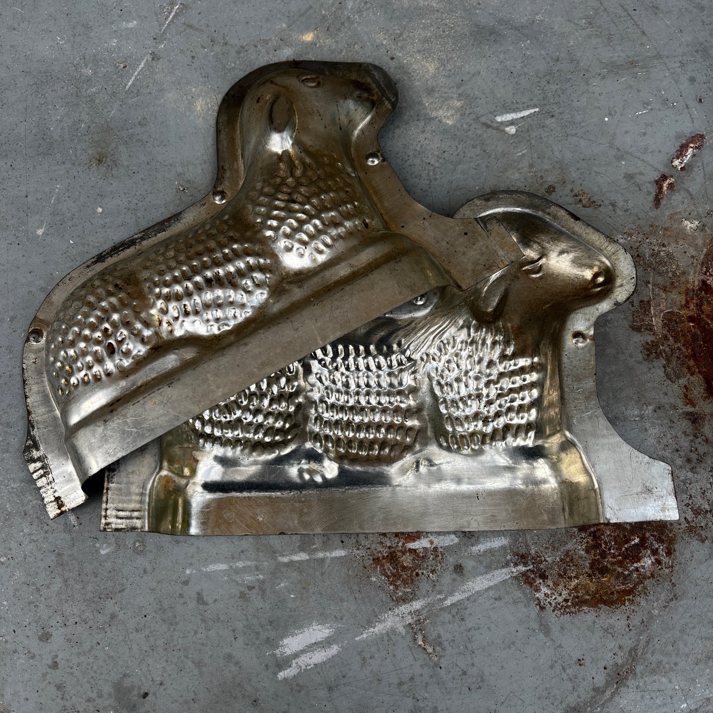 Vintage French chocolate mould shaped like a sheep, made from metal with two halves, featuring detailed wool texture and a classic confectionery design.