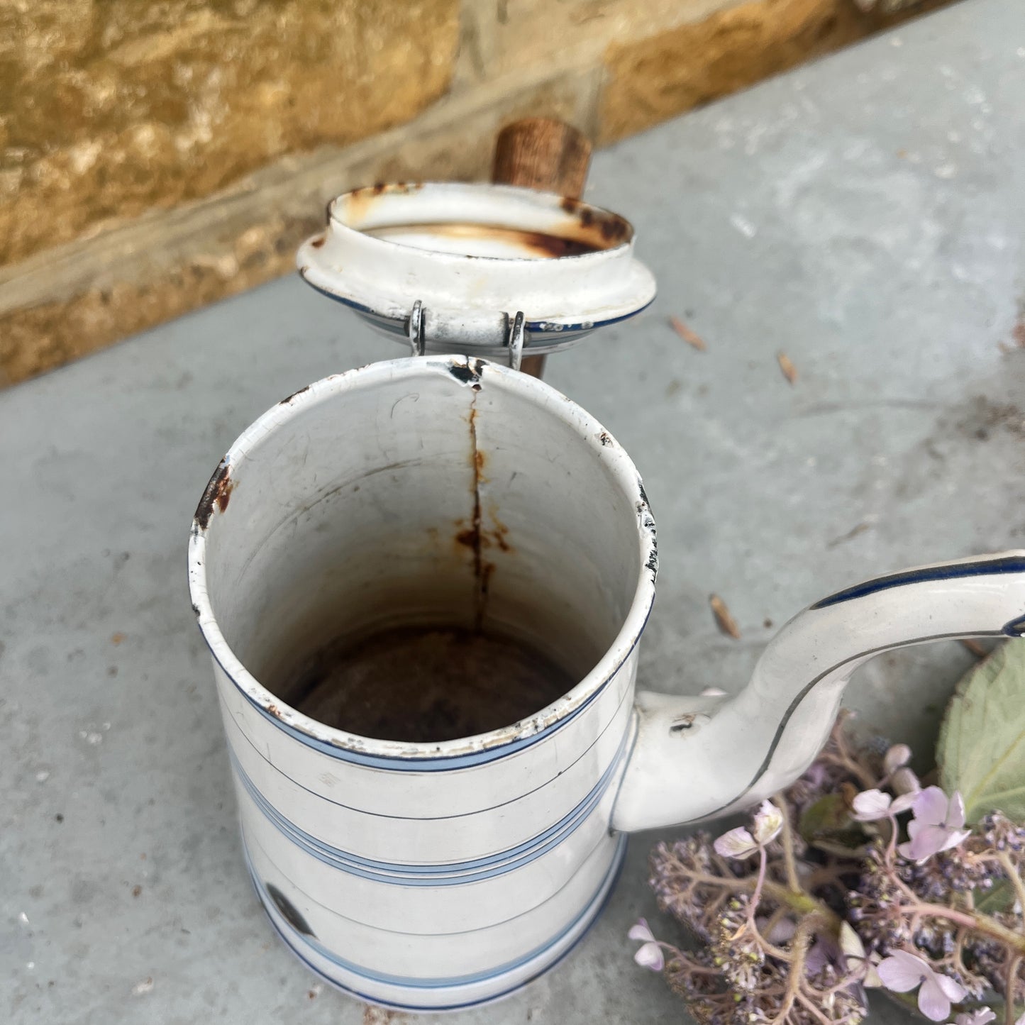 Vintage-style white enamel coffee pot with blue stripes