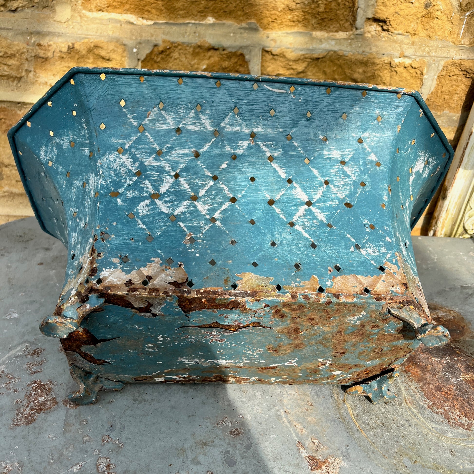 A large, vintage French jardinière in blue metal.  It has a shabby chic aesthetic with visible chips, wear, and some rust on the enamel, adding to its antique charm. Perfect for French country or vintage decor