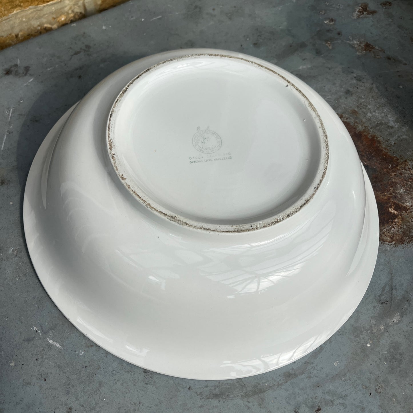 A vintage French Moulin des Loups ceramic wash basin and matching pitcher featuring a classic white glazed finish with delicate pink and green floral decoration.