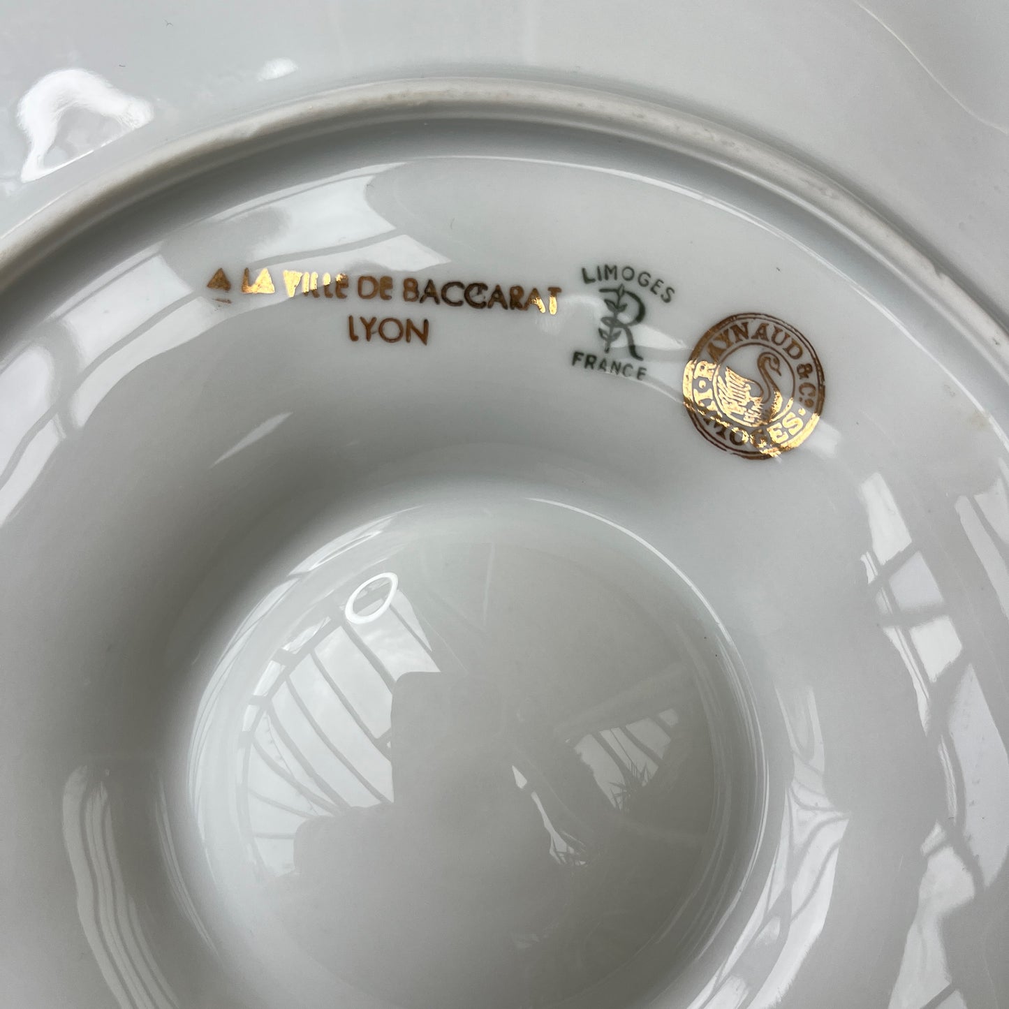 French oyster plates in white porcelain featuring elegant gold detailing along the edges. The plates have a classic, vintage design with subtle scalloped rims, reflecting refined French tableware style.