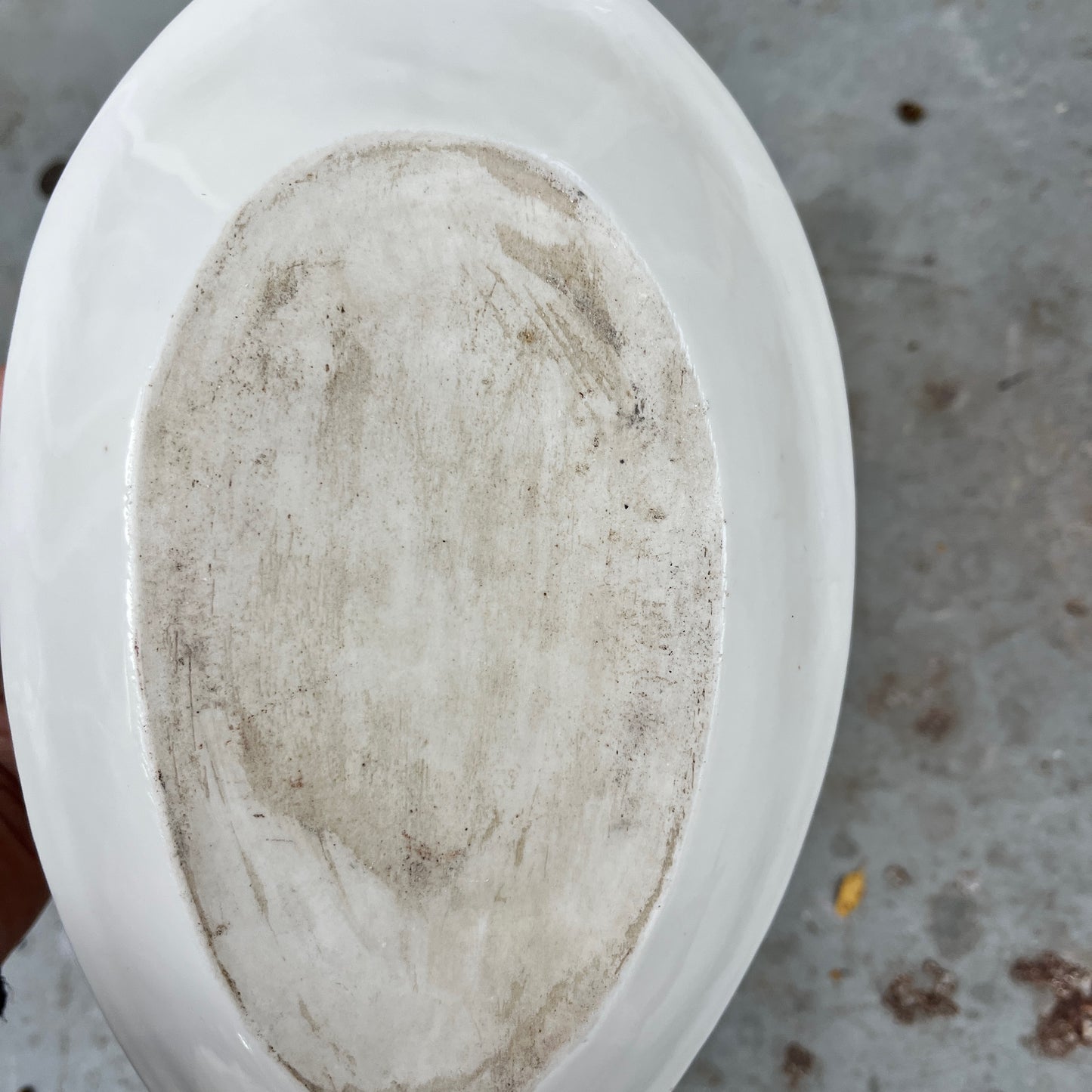 French vintage sauce boat with a fixed saucer, decorated with delicate hand-painted floral motifs and gilded accents along the edges. The piece has an elegant, classic design reflecting refined French tableware style.