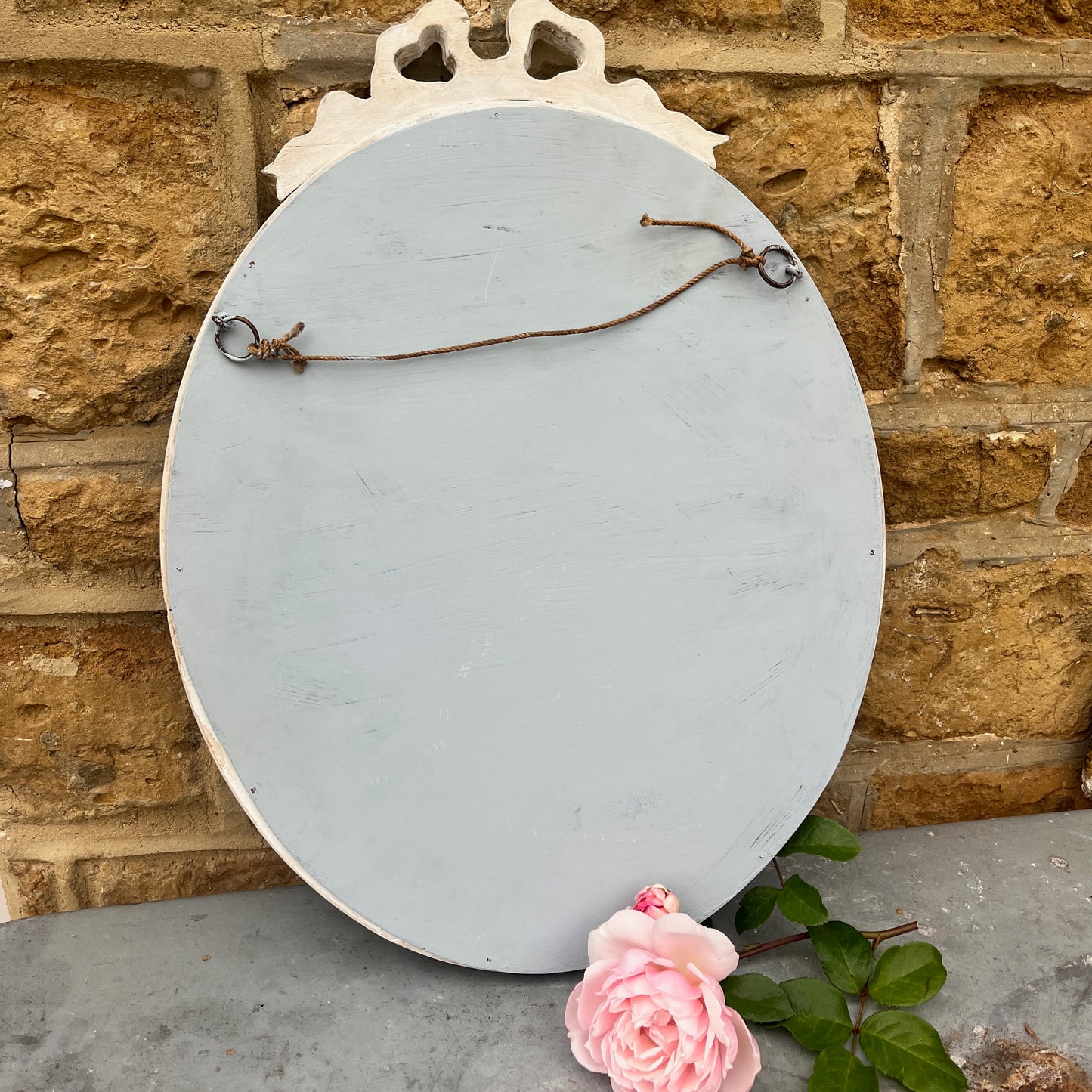 The back of a French style shabby chic oval mirror