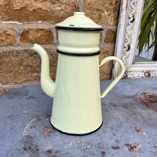A vintage French yellow enamel coffee pot, circa 1920s, with a soft yellow body and black trim. It includes all four brewing pieces, showing minor chips and rust that add to its authentic patina