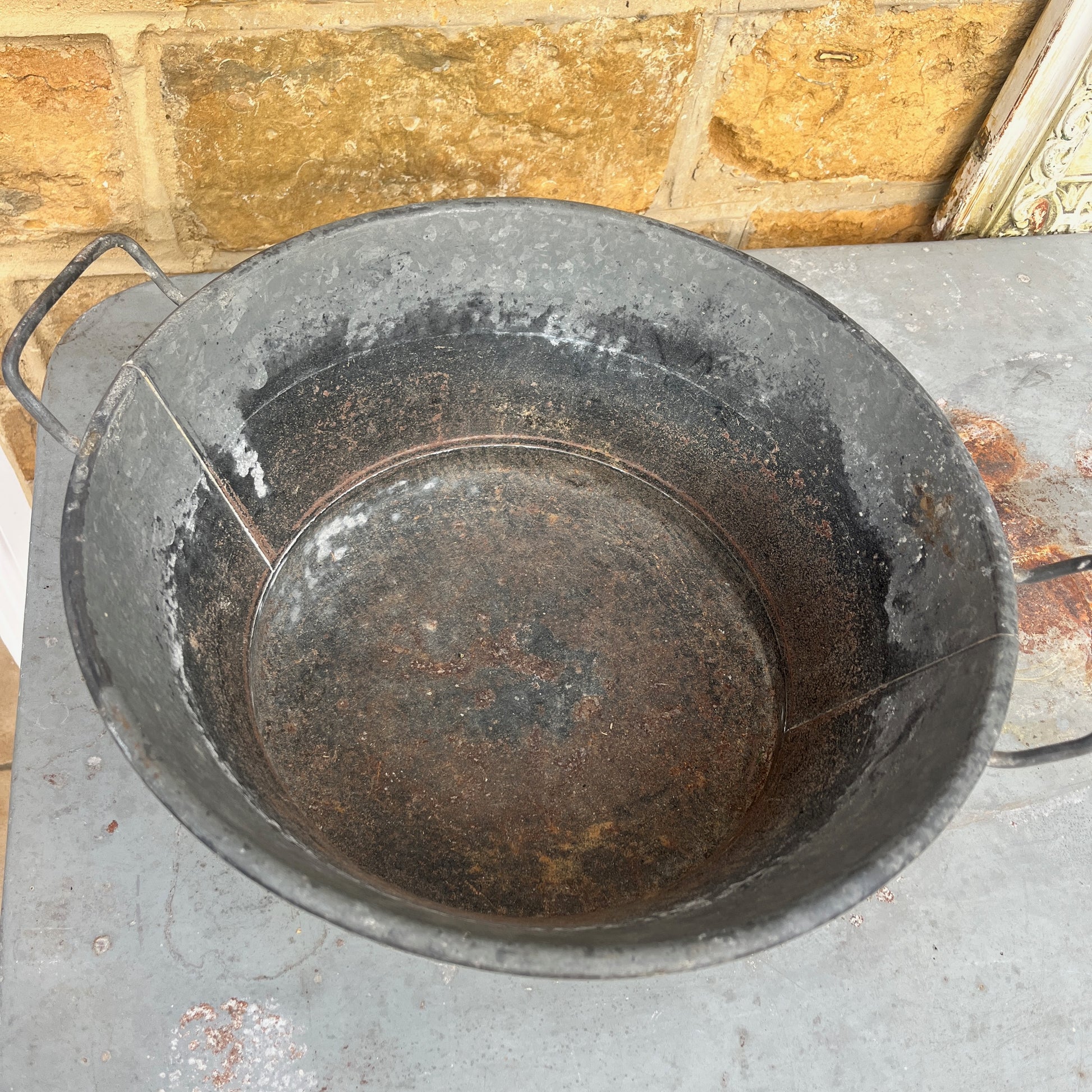 Rust-covered metal vintage planter