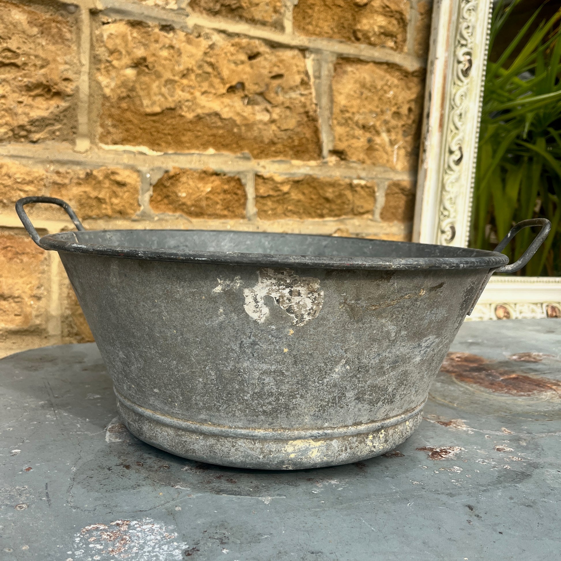 Rust-covered metal vintage planter