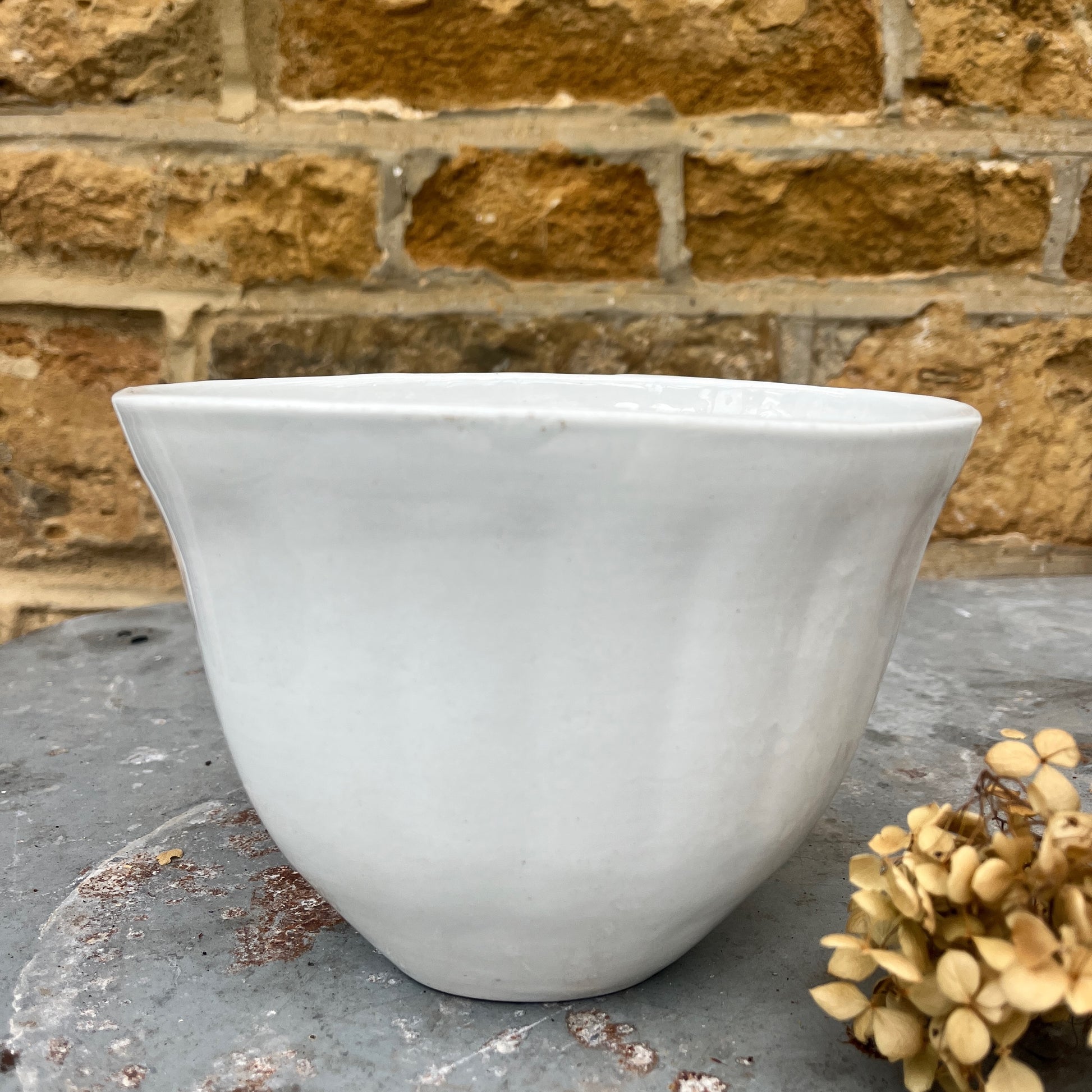 A vintage ceramic white jelly mould with a smooth, glossy finish, featuring a classic fluted design and an oval shape