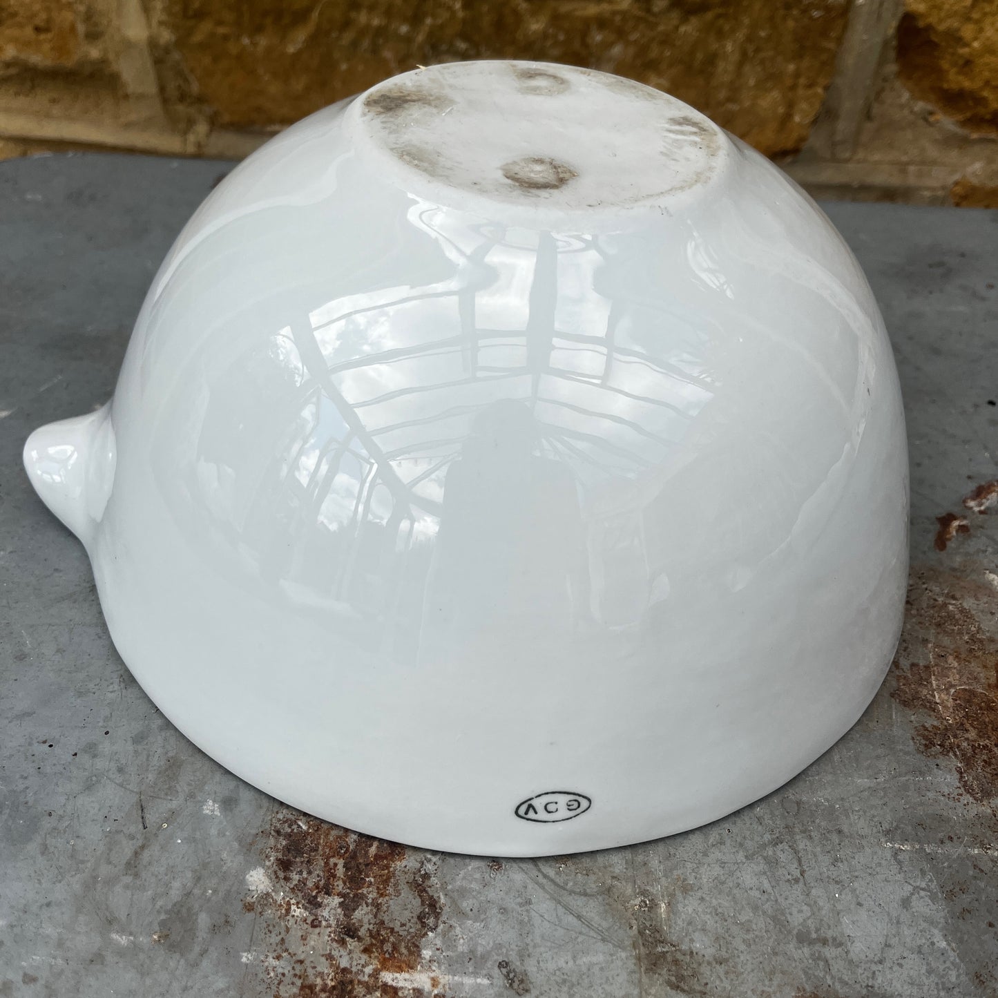 A large vintage GDV porcelain pestle and mortar with a classic white glazed finish and substantial, heavy design. The deep bowl features a pouring lip and sturdy rounded base, accompanied by a matching porcelain pestle