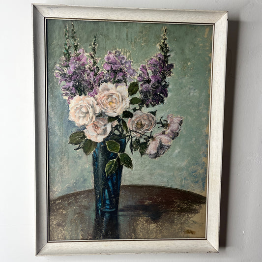 Framed painting of a bouquet of flowers in a vase on a textured surface.