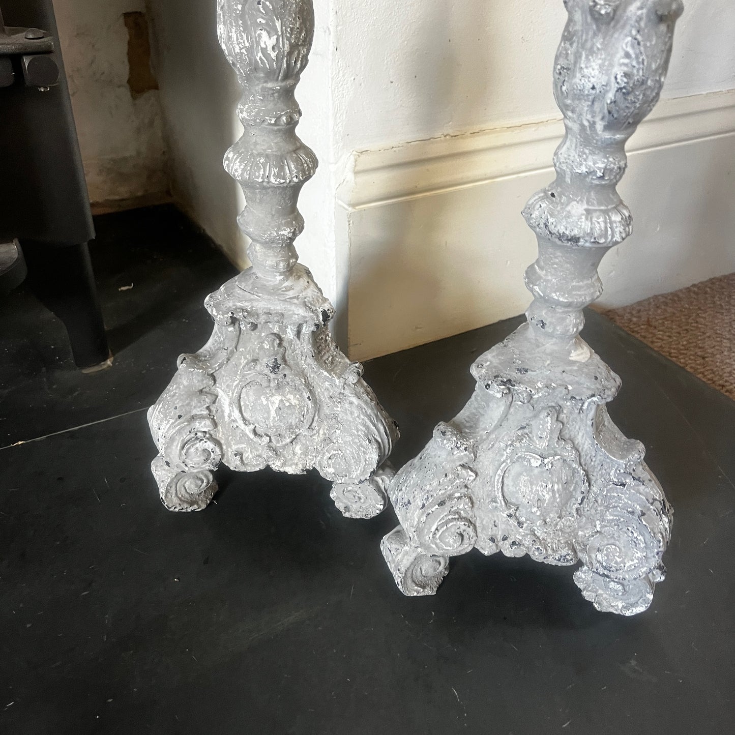 A pair of vintage French decorative candle holders with an elegant distressed finish and ornate detailing