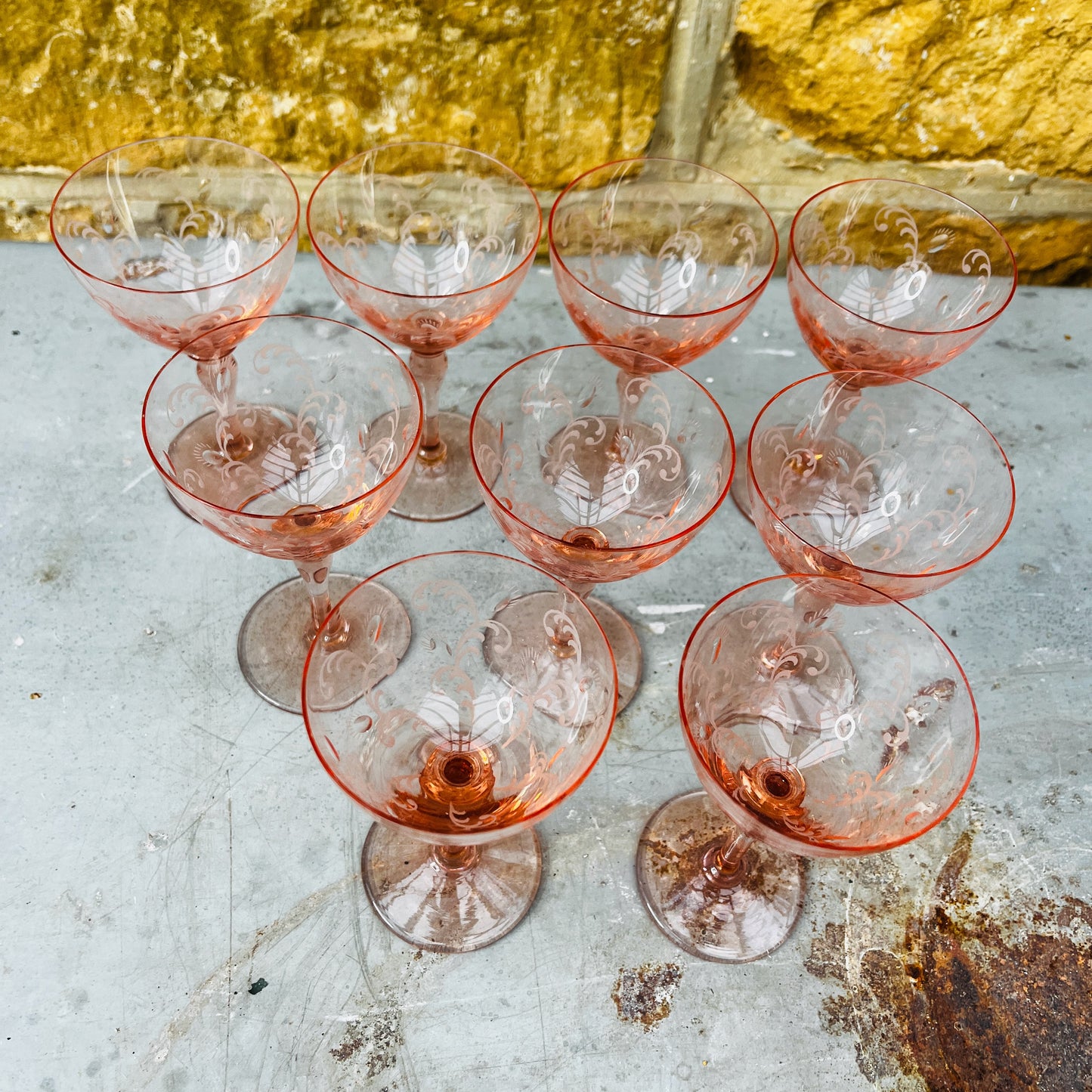 Blush pink depression glass coupes with a delicate, translucent finish. The shallow, rounded bowls feature vintage 1930s design, showcasing elegant, soft pastel tones.