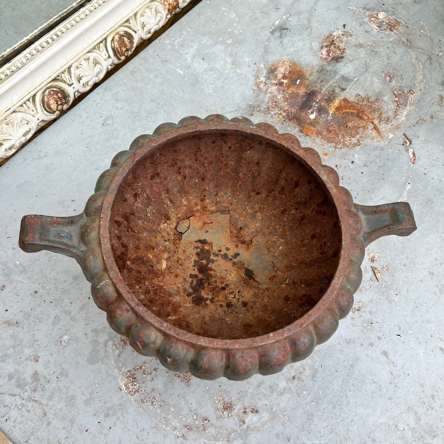 A round French jardinière crafted from metal. The planter has a classic, slightly weathered finish, with subtle decorative accents, exuding rustic French elegance