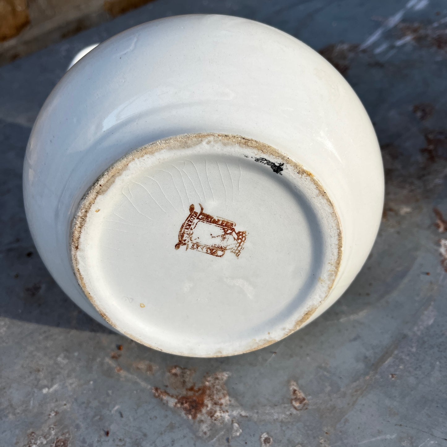 Simple French white ceramic jug with a rounded body, curved handle, and minimalist glazed finish in a classic utilitarian style.