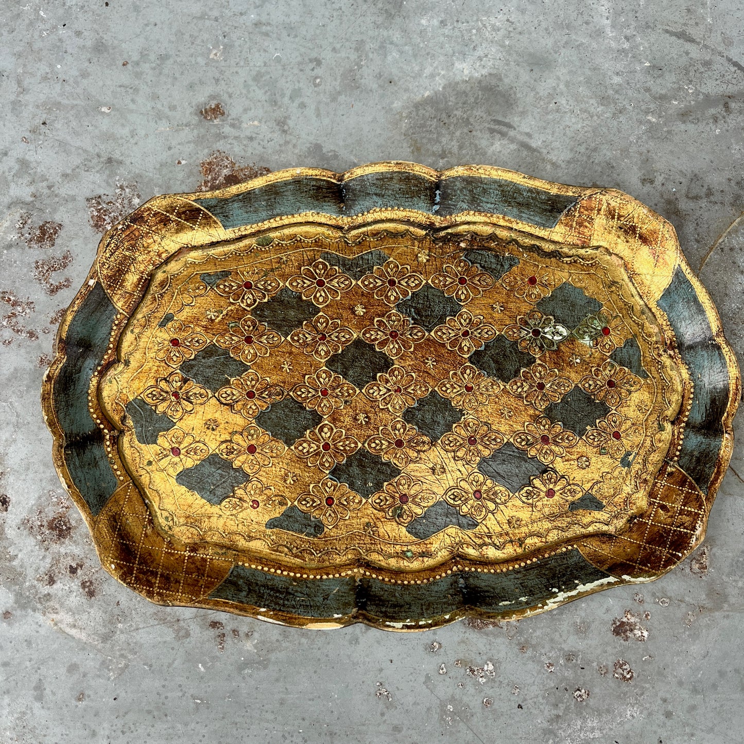 Decorative gold and blue tray on a textured surface