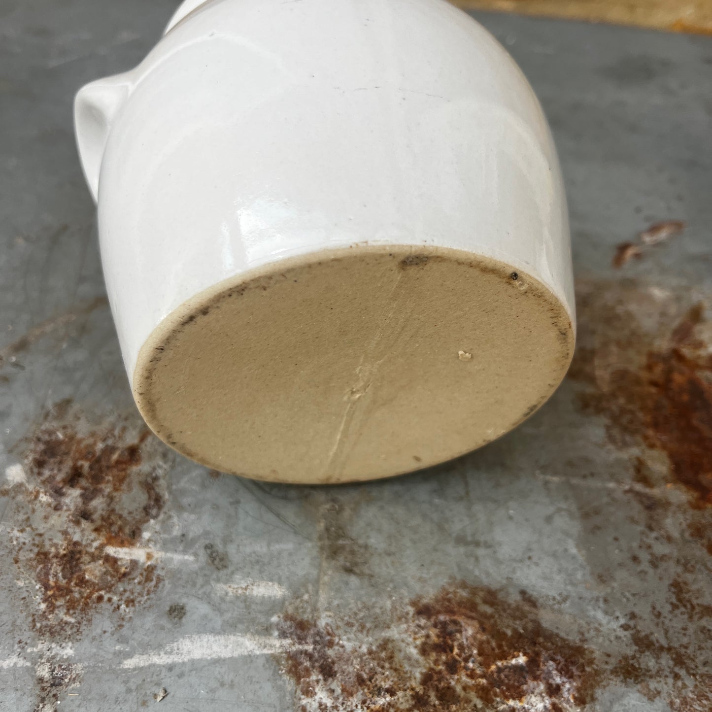 A small vintage white confit pot with a classic rounded shape and a beautifully aged glazed finish.