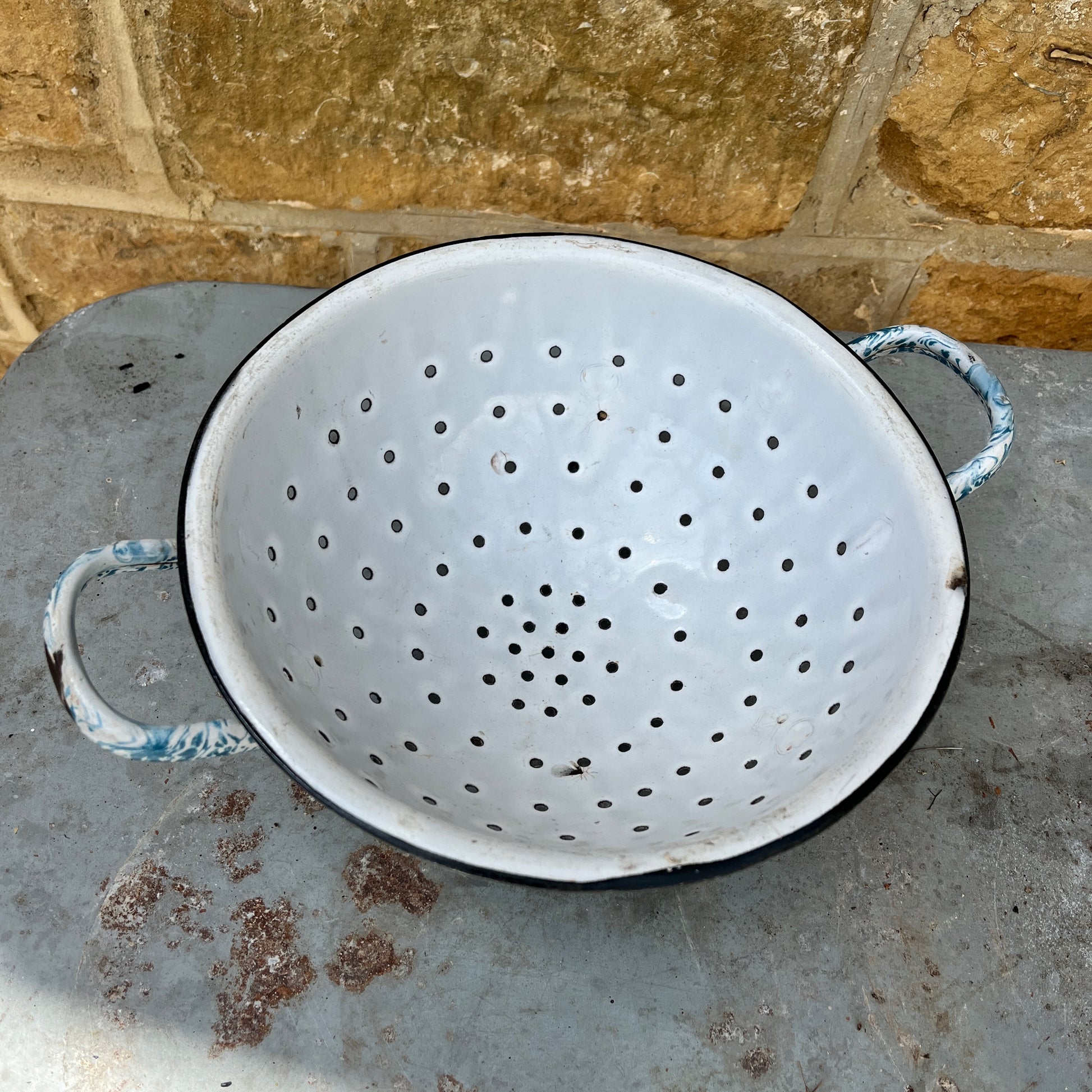 Decorative vintage enamelware colander with blue and white pattern