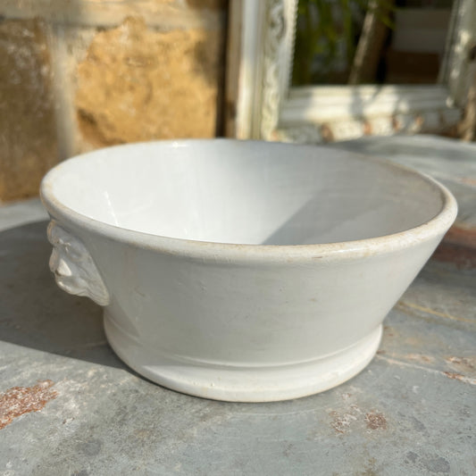 White vintage ceramic bowl with lion's head features
