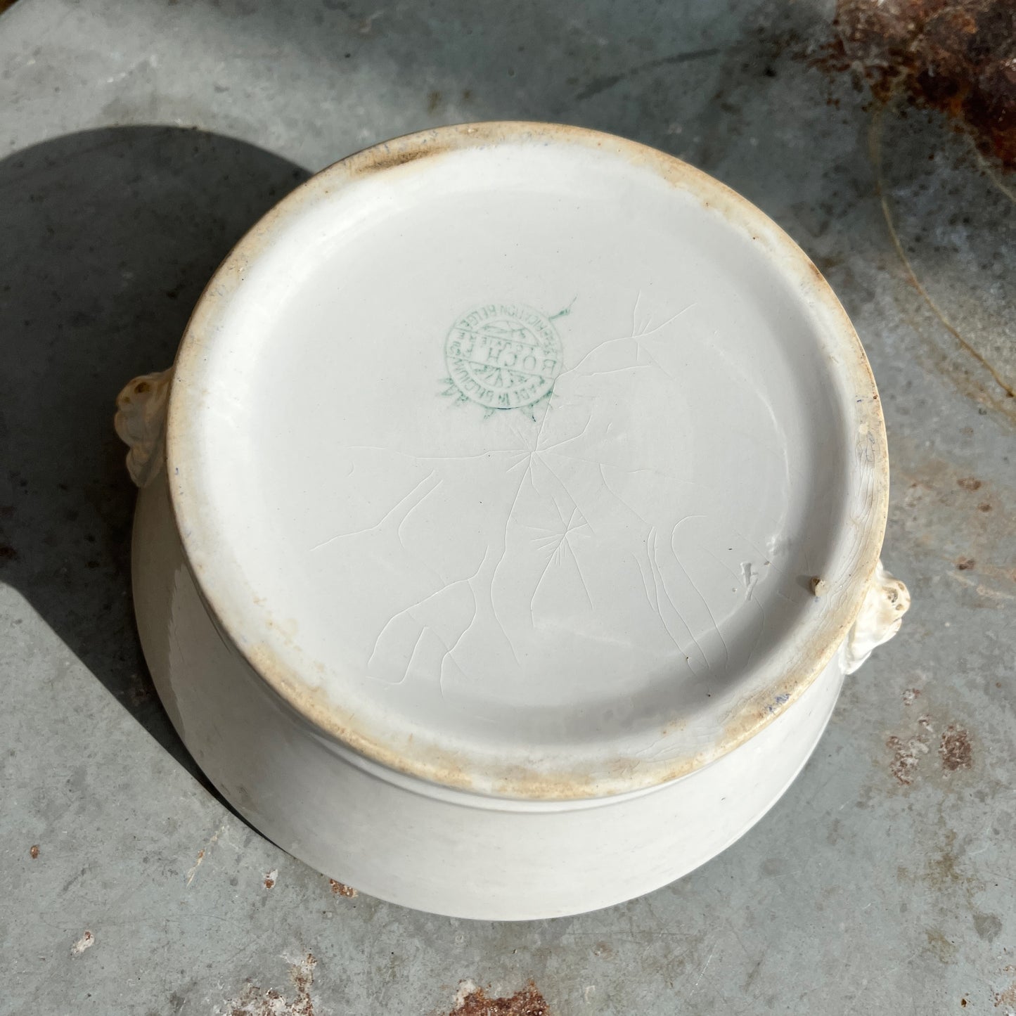 White vintage ceramic bowl with lion's head features
