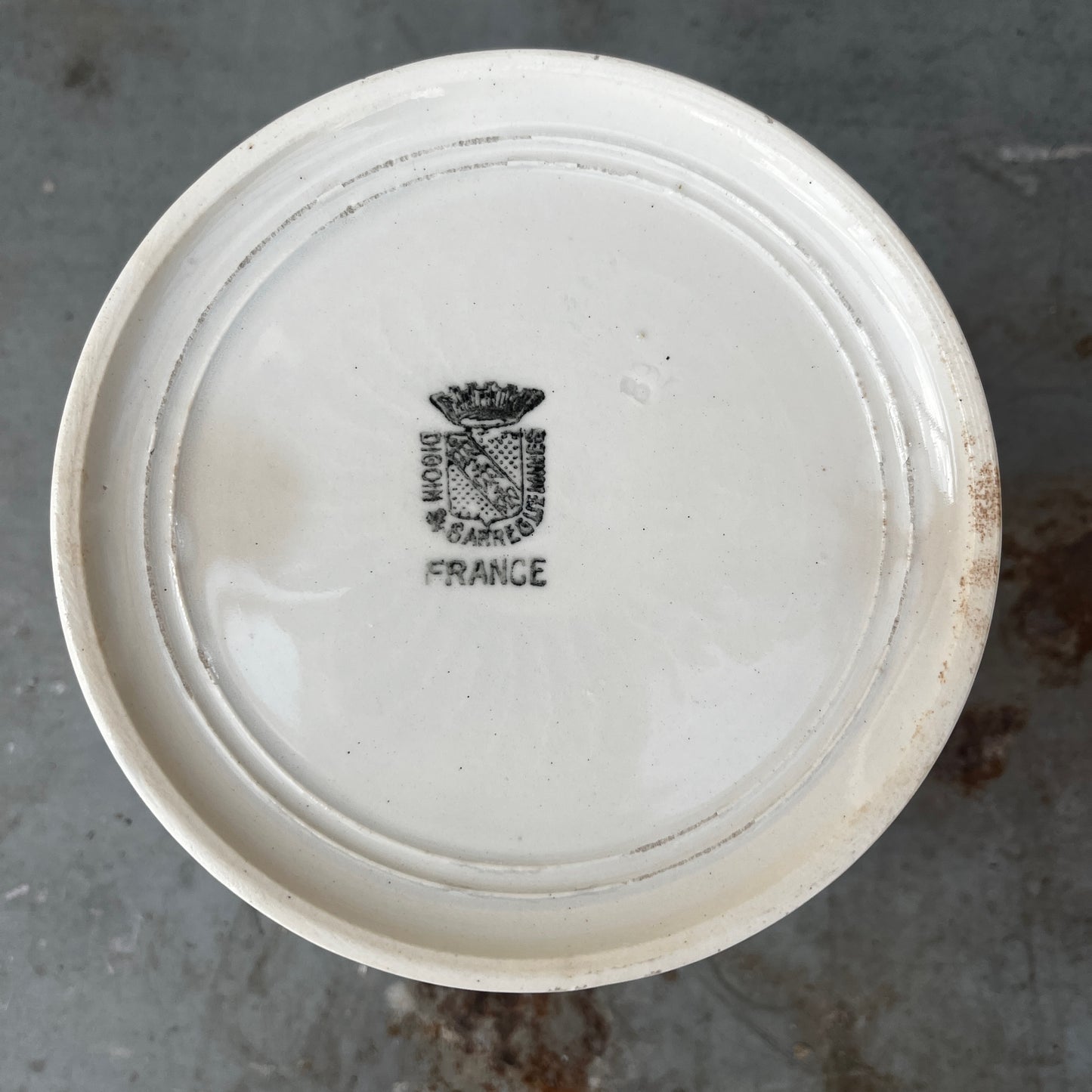 A vintage white ceramic storage pot with a simple cylindrical shape and a rolled rim, finished in a smooth glossy glaze. Its clean, understated design reflects traditional farmhouse and apothecary pottery, making it ideal for storing kitchen utensils, herbs, or small household items.