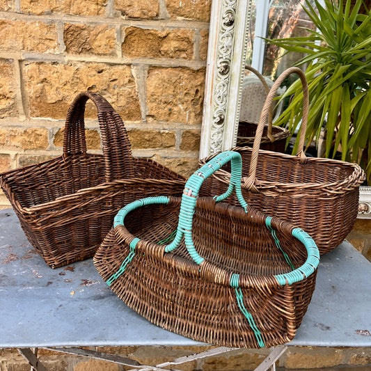 Assorted wicker baskets in various shapes and sizes, made from natural woven materials.