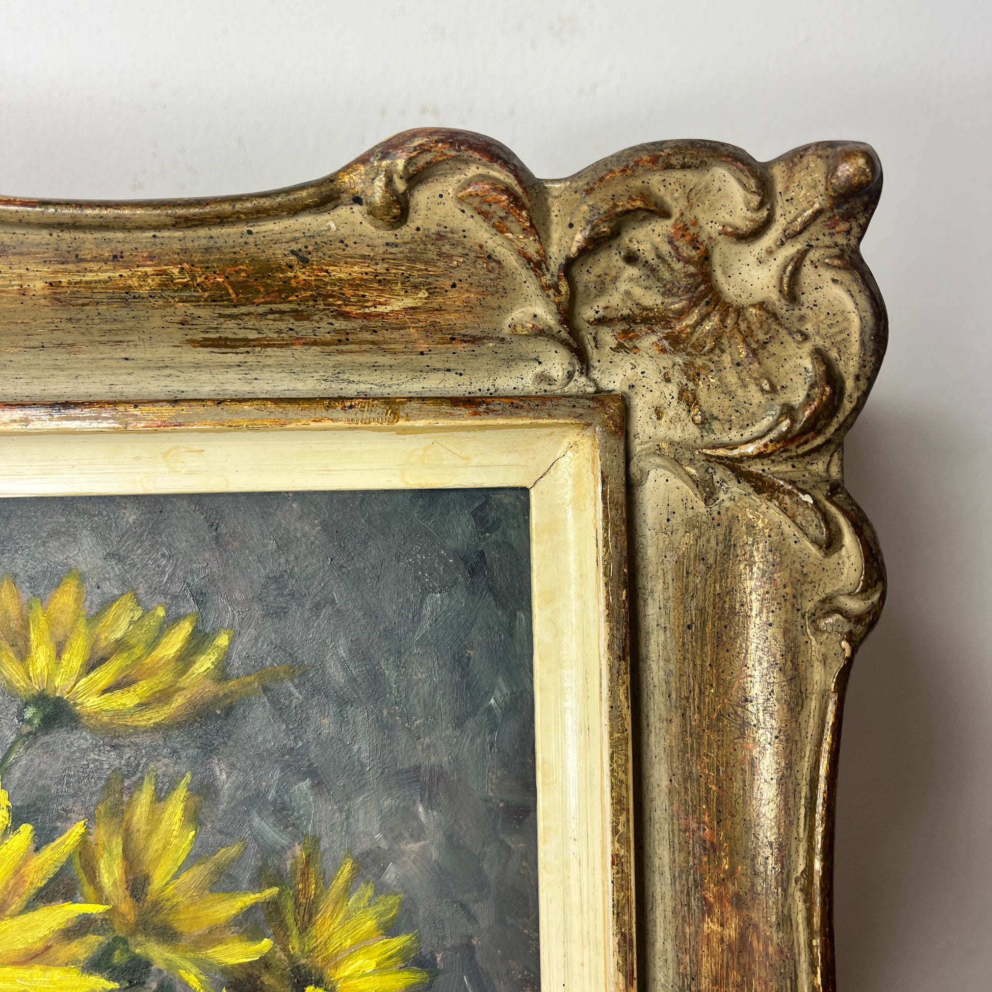 A vintage still life oil on board painting depicting a delicate bouquet of blooming yellow chrysanthemums in a grey vase, set against a softly lit table with subtle shadows and aged patina.