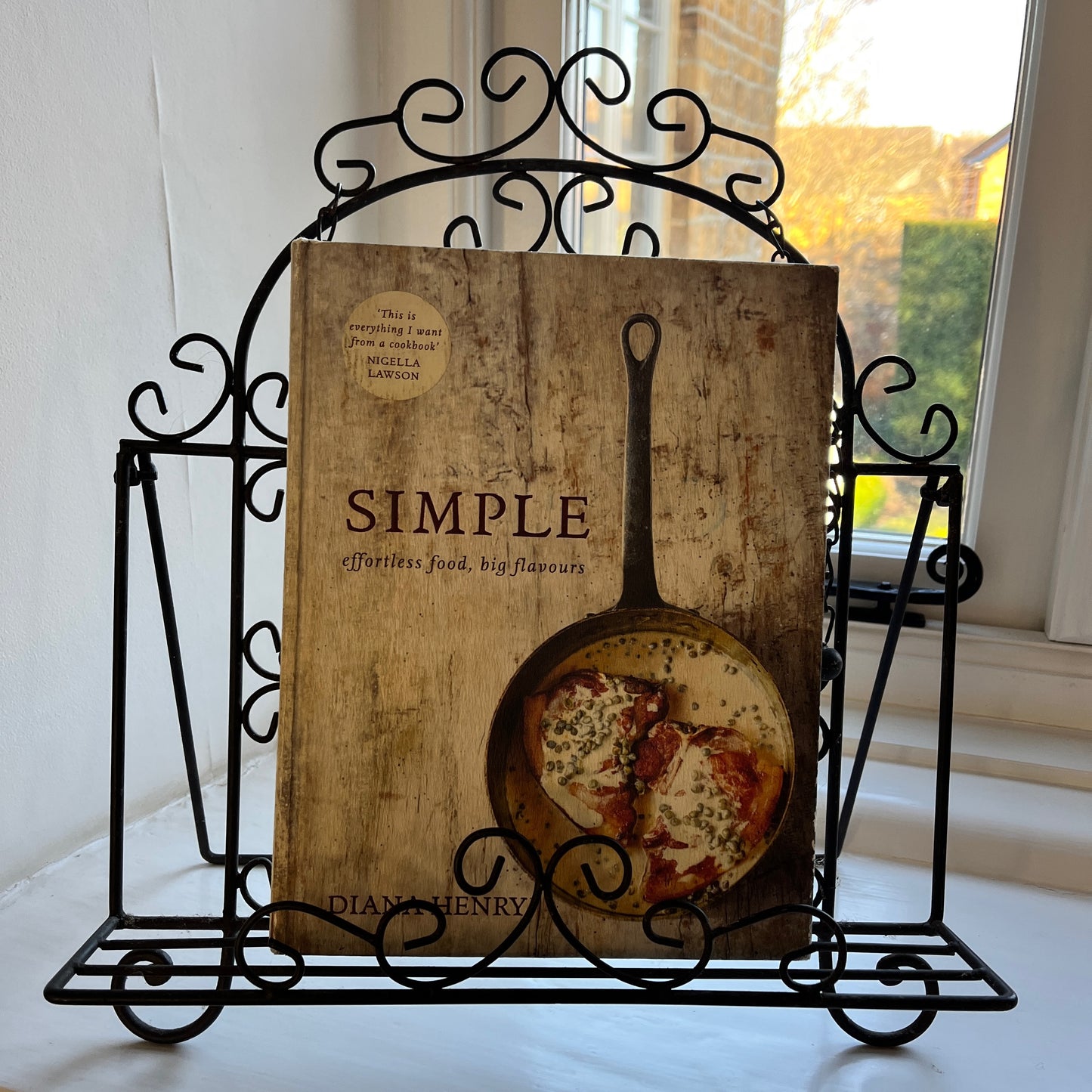 An intricantly designed wire book holder, featurning elegant patterns - perfect for holding a book