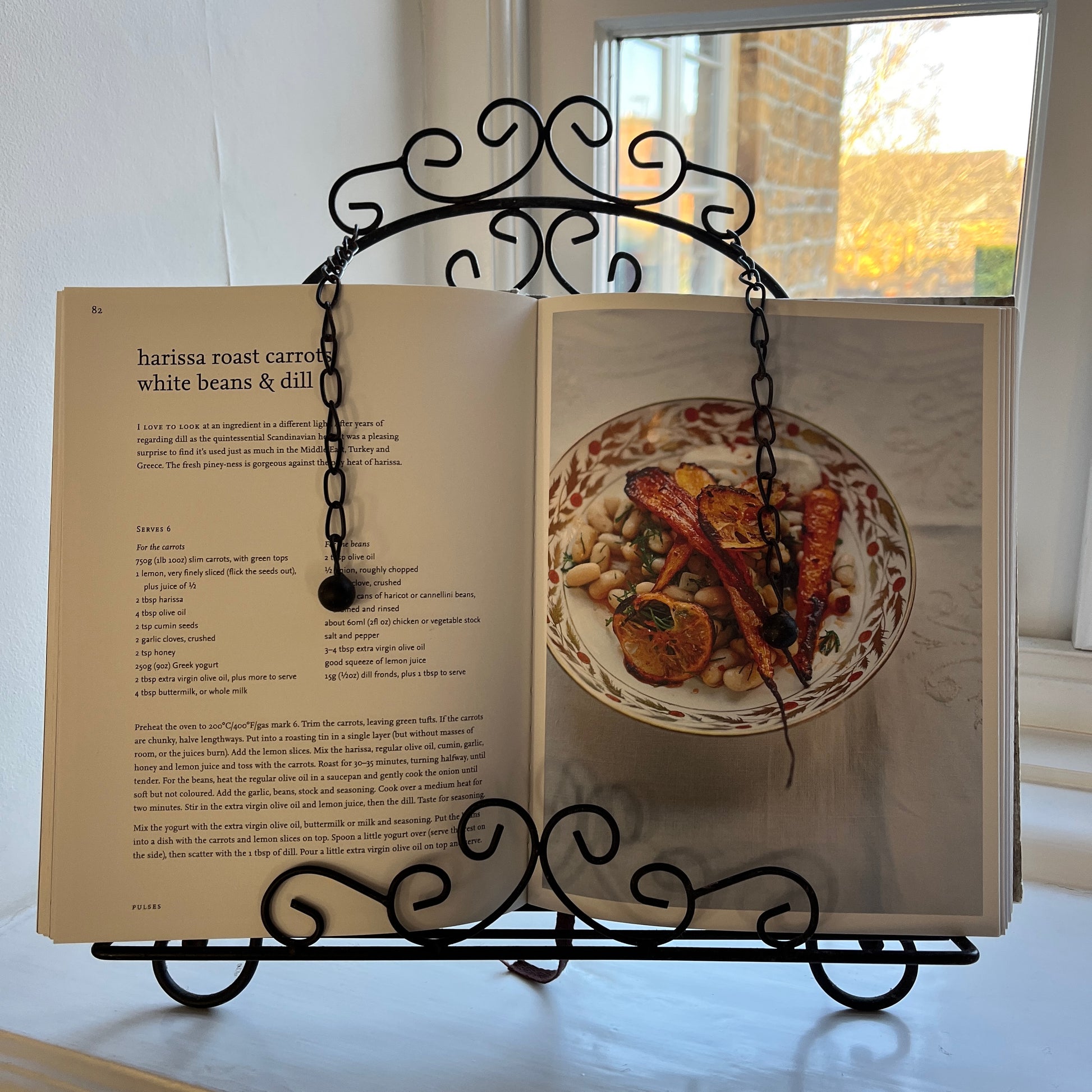 An intricantly designed wire book holder, featurning elegant patterns - perfect for holding a book