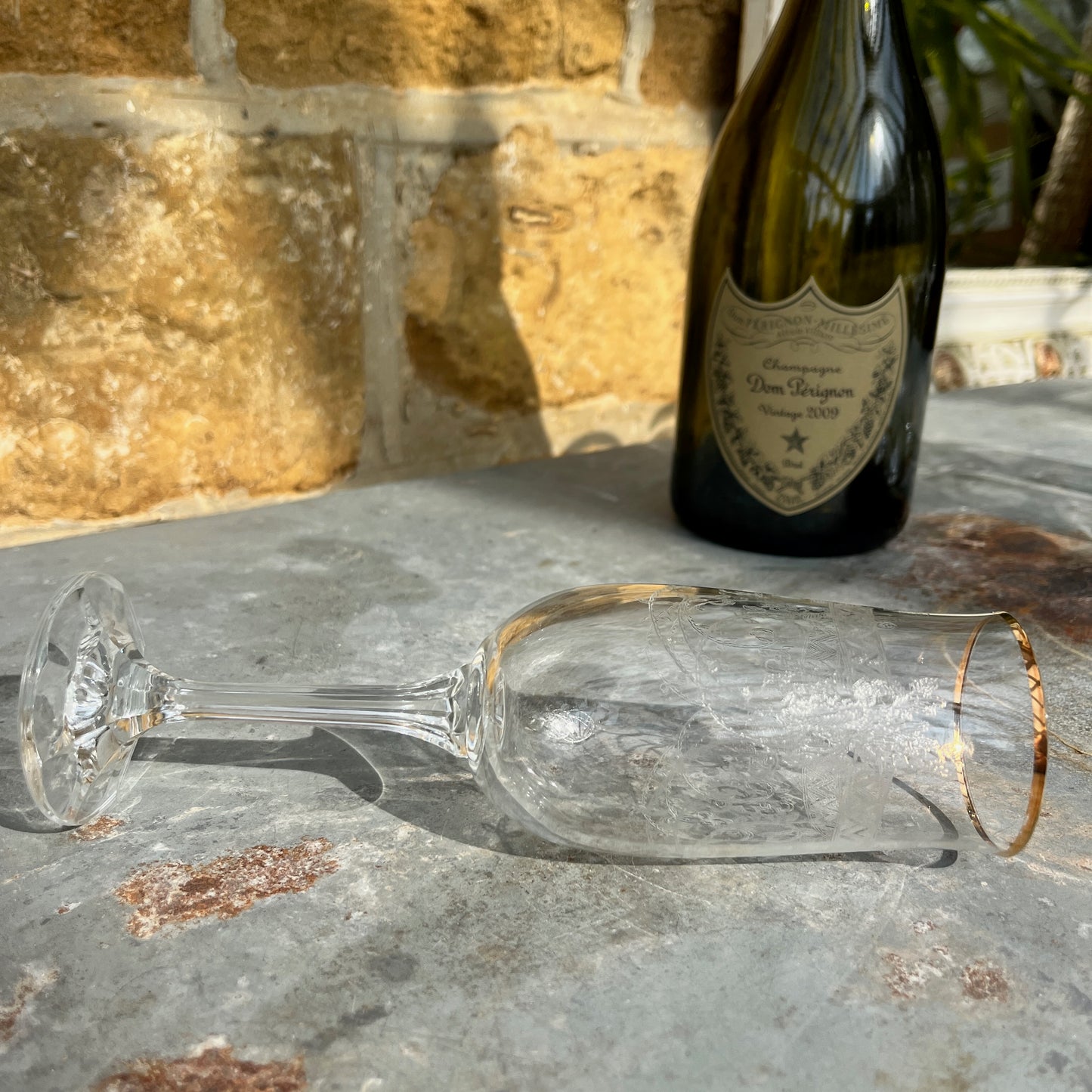 A set of six vintage champagne flutes with elegant gold rims and intricately etched glass, circa mid-20th century. Each flute features delicate floral or geometric etchings on the bowl, complemented by a fine gold band around the rim.