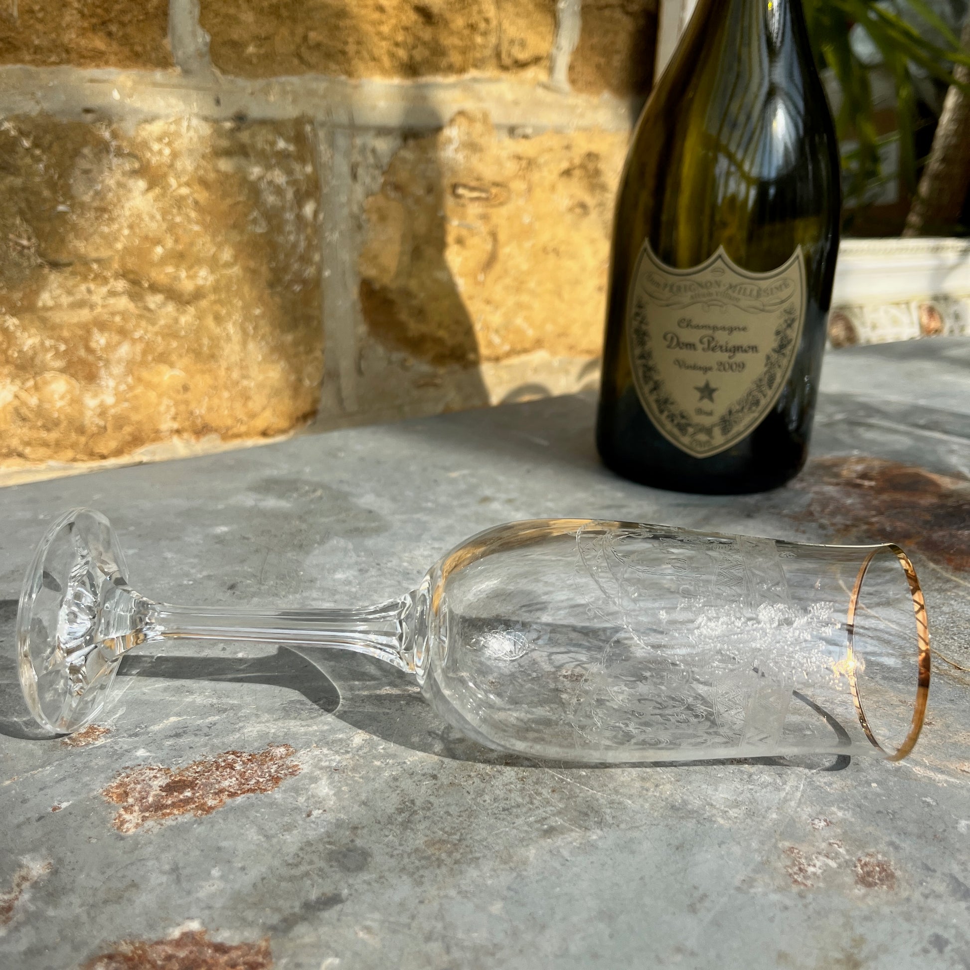 A set of six vintage champagne flutes with elegant gold rims and intricately etched glass, circa mid-20th century. Each flute features delicate floral or geometric etchings on the bowl, complemented by a fine gold band around the rim.