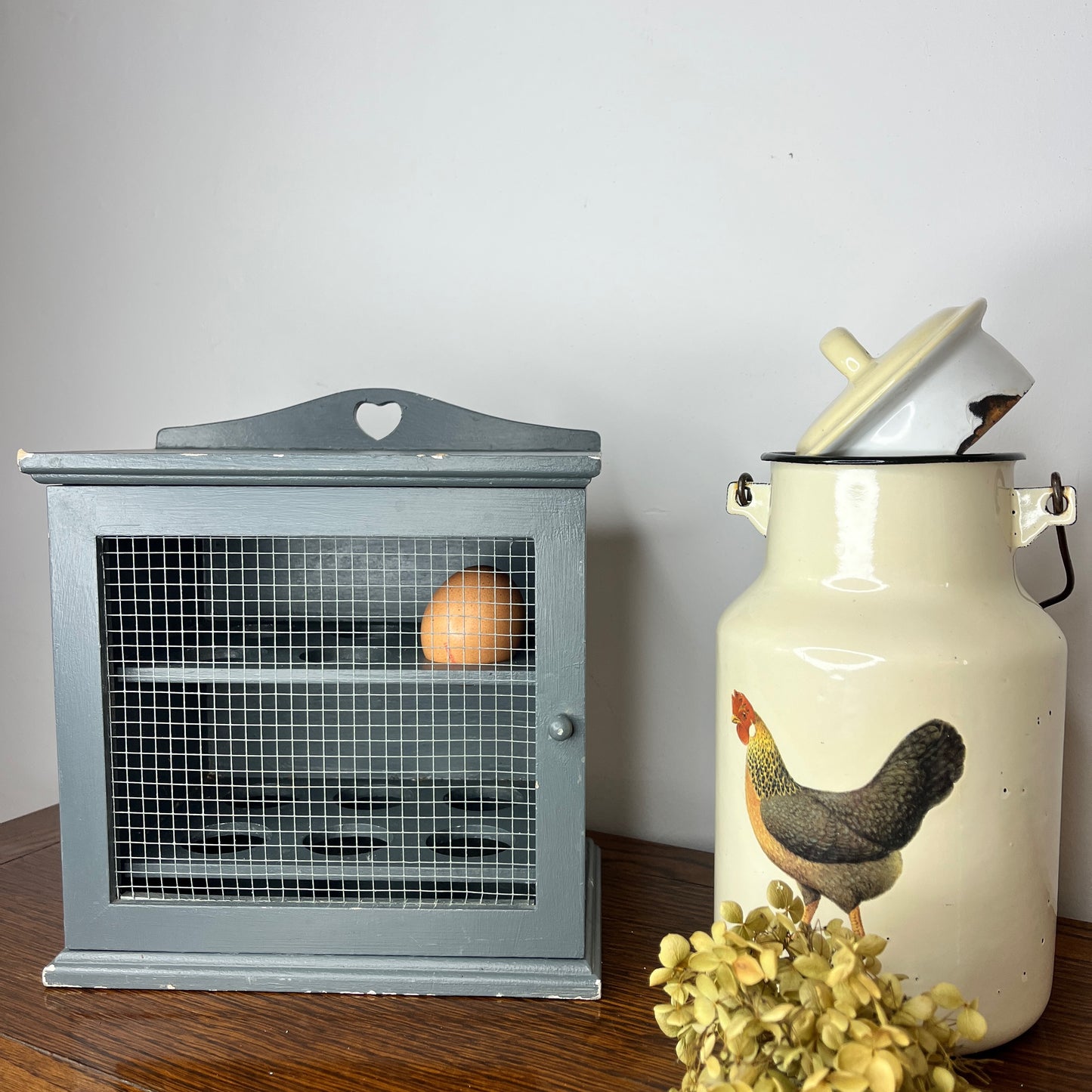 Vintage blue egg cupboard with a rustic, chippy finish