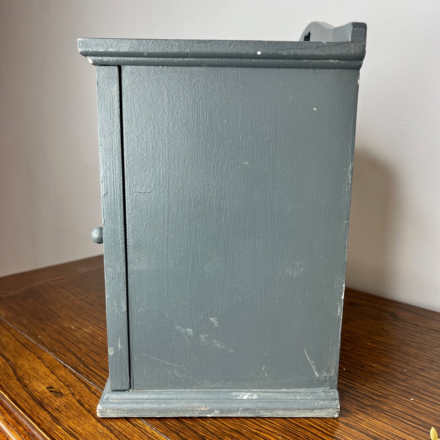 Vintage blue egg cupboard with a rustic, chippy finish