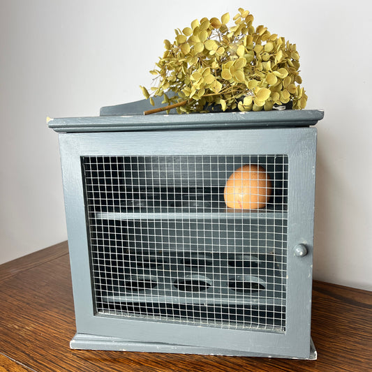 Vintage blue egg cupboard with a rustic, chippy finish
