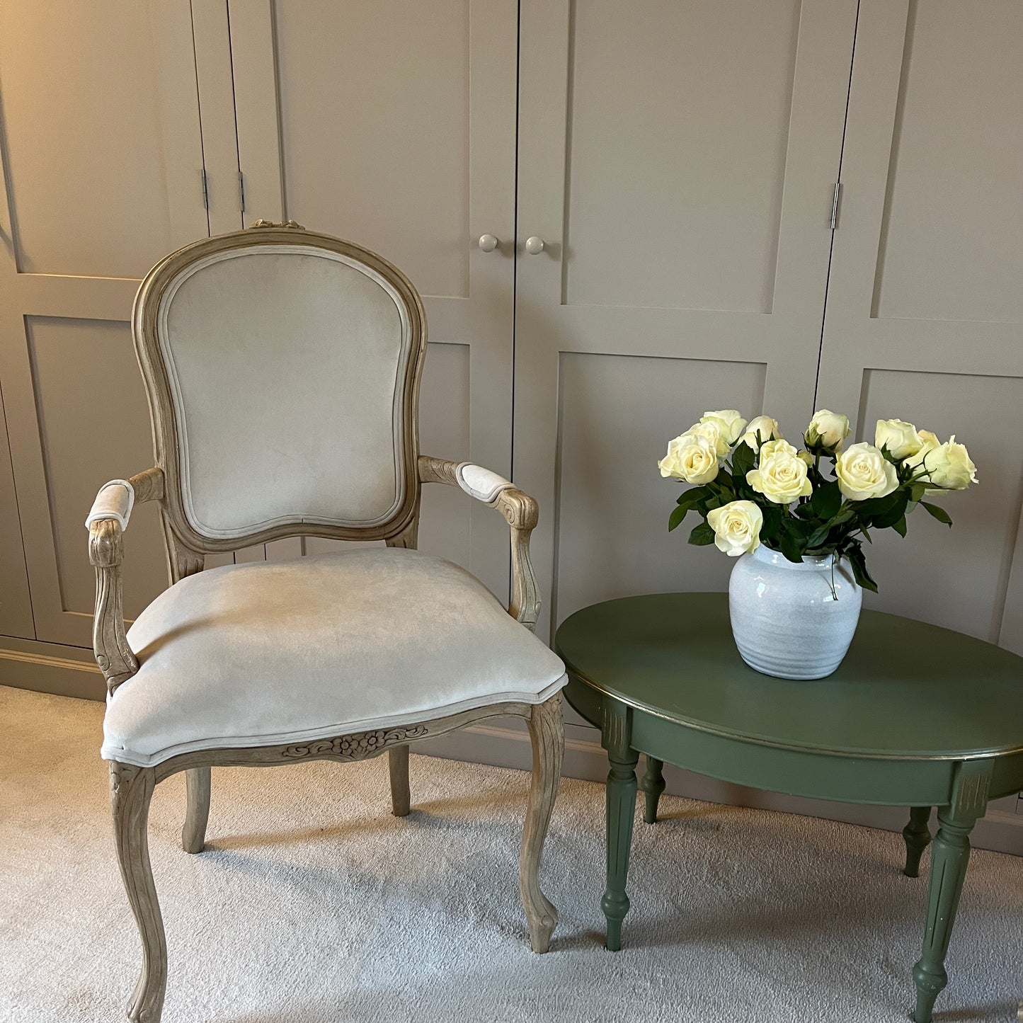 Pair of French-style carver chairs, freshly upholstered in luxurious cream velvet, showcasing ornate carvings and a refined, elegant design.