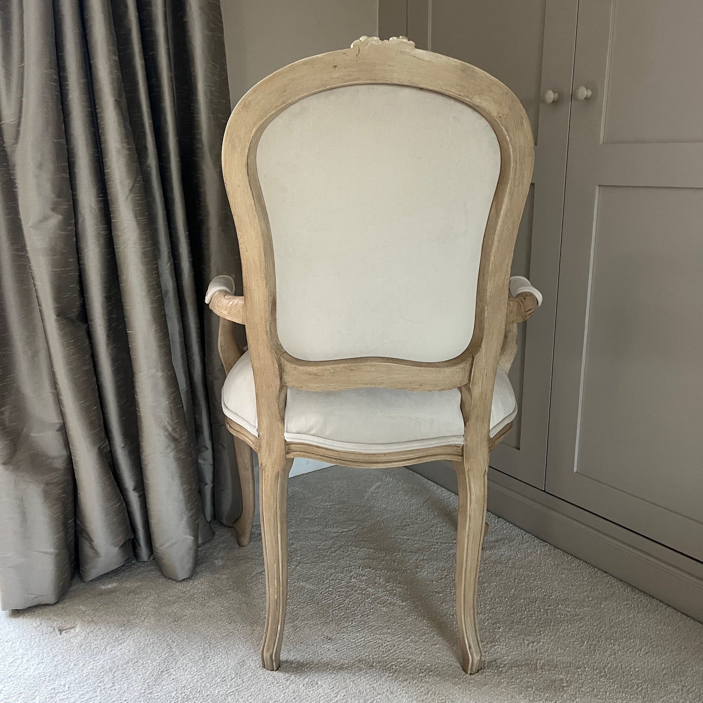 Pair of French-style carver chairs, freshly upholstered in luxurious cream velvet, showcasing ornate carvings and a refined, elegant design.