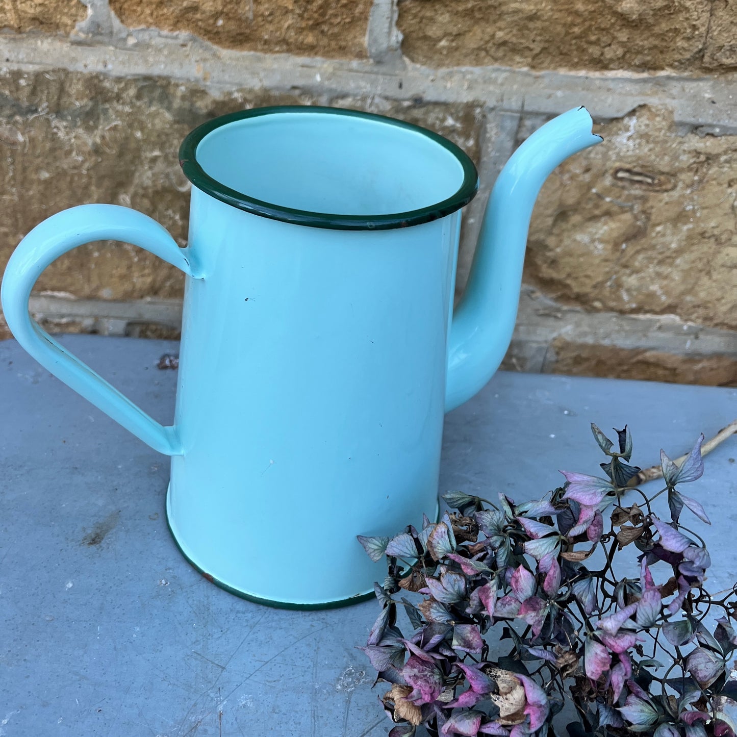 Vintage French enamel jug in soft green with a darker green rim