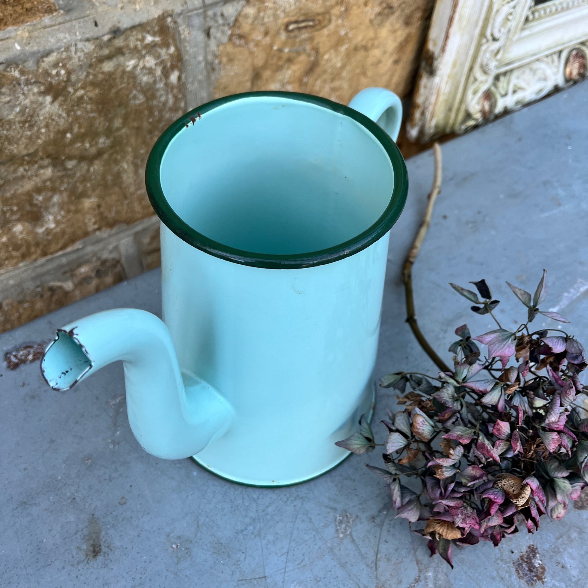 Vintage French enamel jug in soft green with a darker green rim