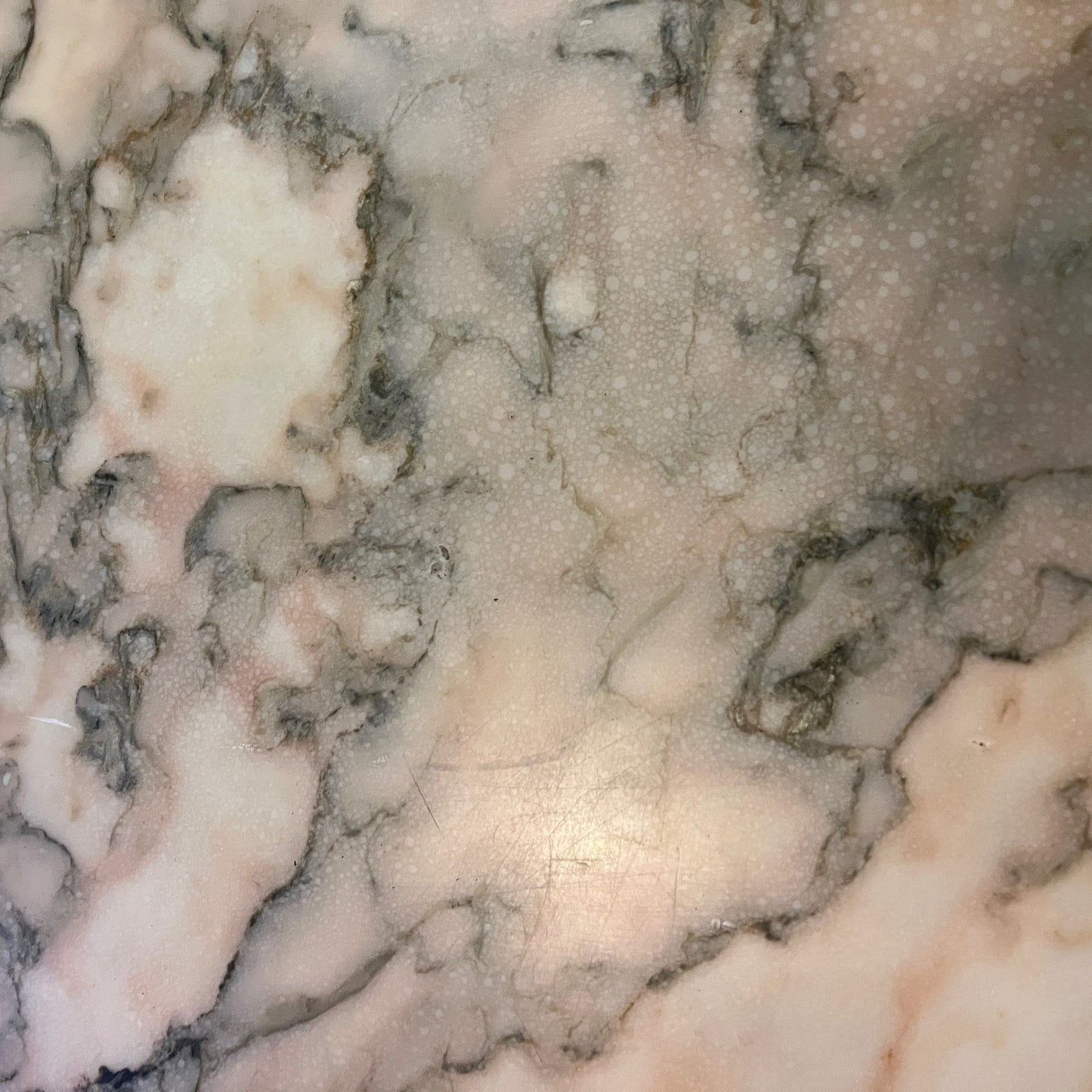 A French coffee table featuring a smooth marble top in creamy white with subtle veining, supported by an ornate brass base with carved details and gracefully curved legs, exuding timeless elegance and luxury.