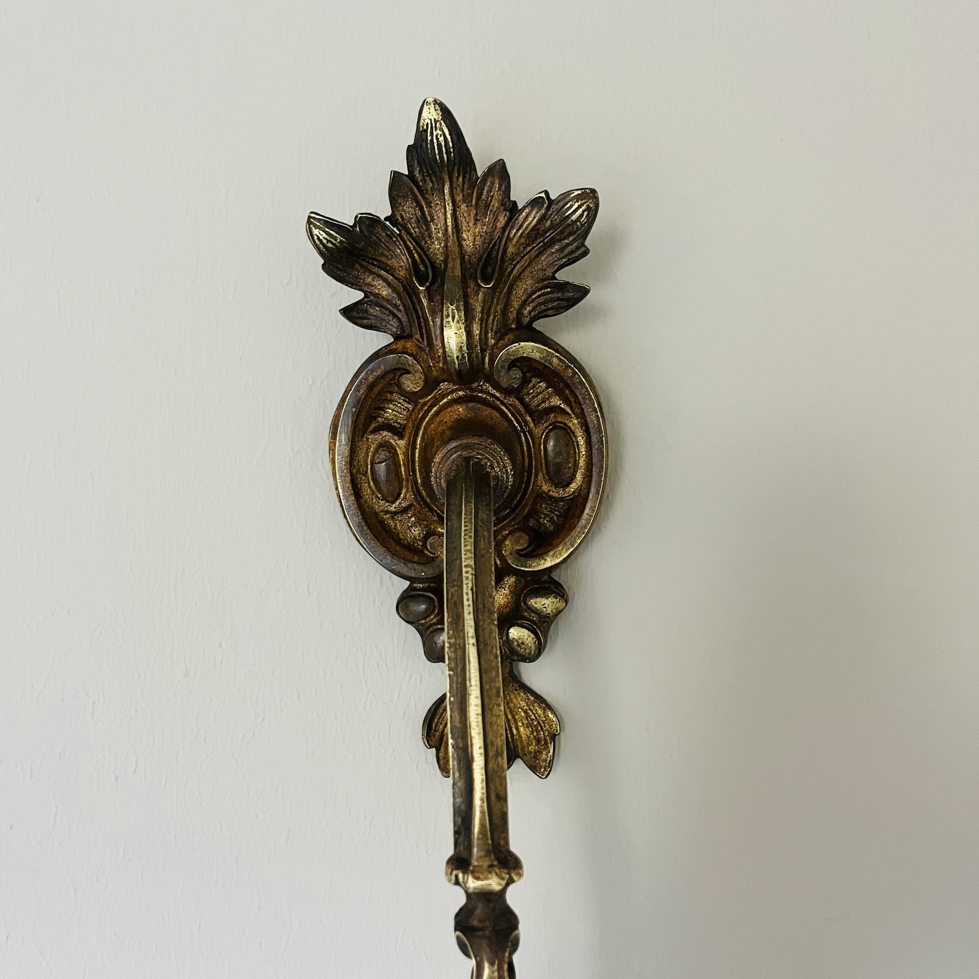 A pair of French antique ormolu tie backs from the 19th century, intricately crafted with gilded bronze, showcasing ornate floral and scroll designs, adding a touch of opulent elegance to vintage decor.