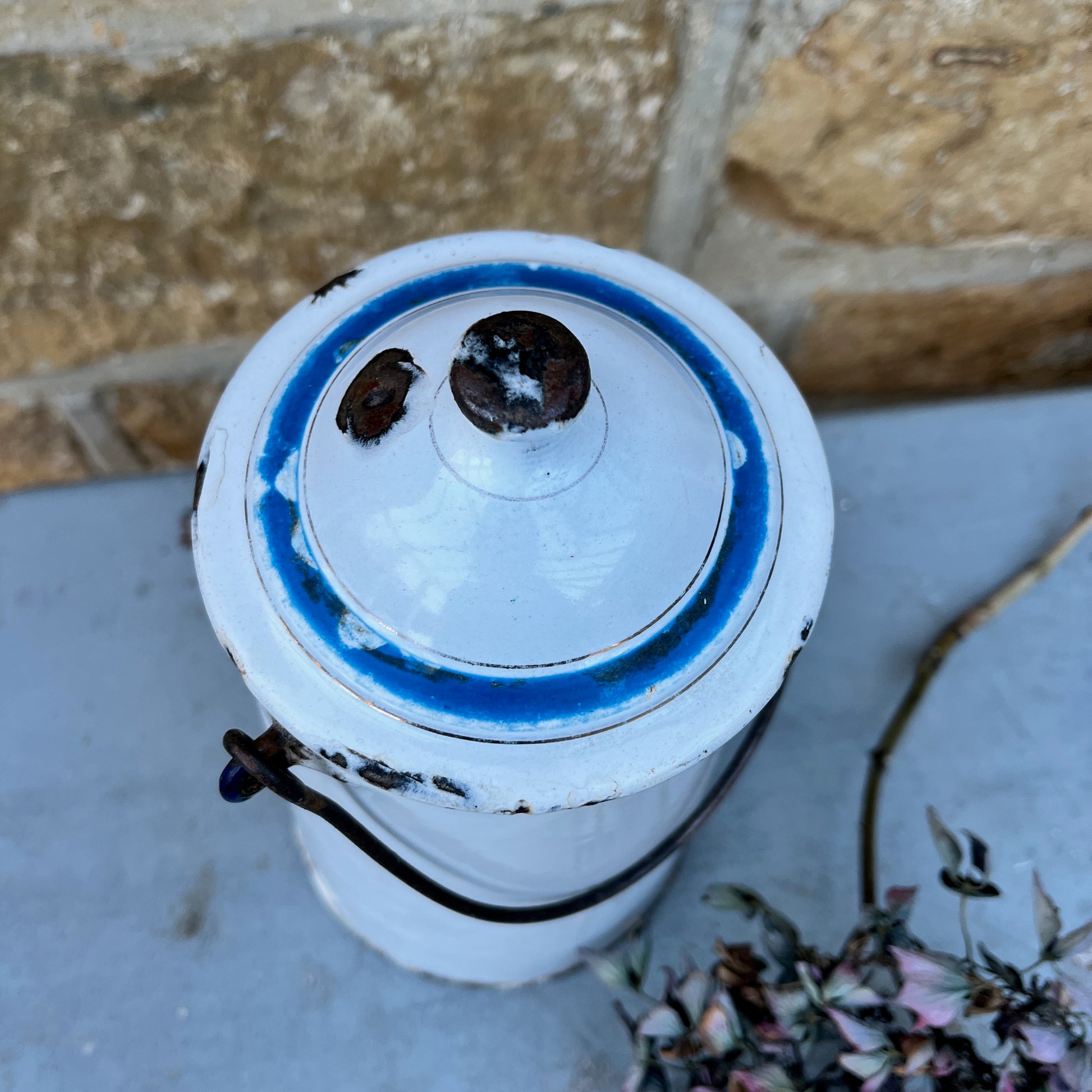 Vintage French milk churn in white with black handle and separate lid with blue detail