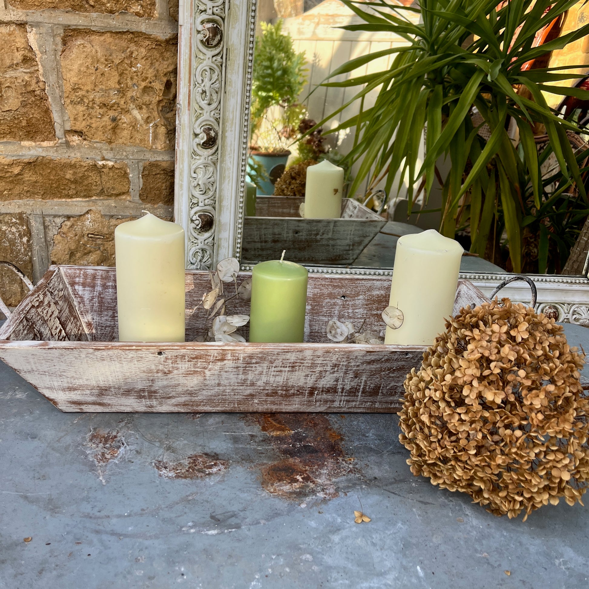 A large wooden tray featuring handles at both ends, crafted with a rustic finish, ideal for decorative display